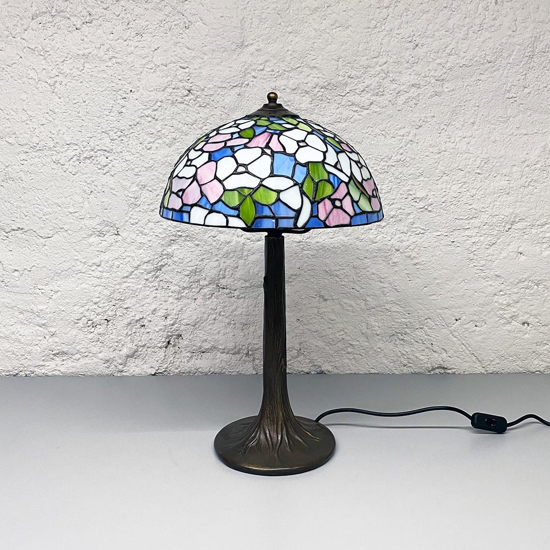 Italian Mid-Century Modern Tiffany table lamp with liberty colored glass, 1960s
Tiffany table lamp with iron base with liberty colored glass lampshade.

Very good condition

Measures 33 x 55 H cm.