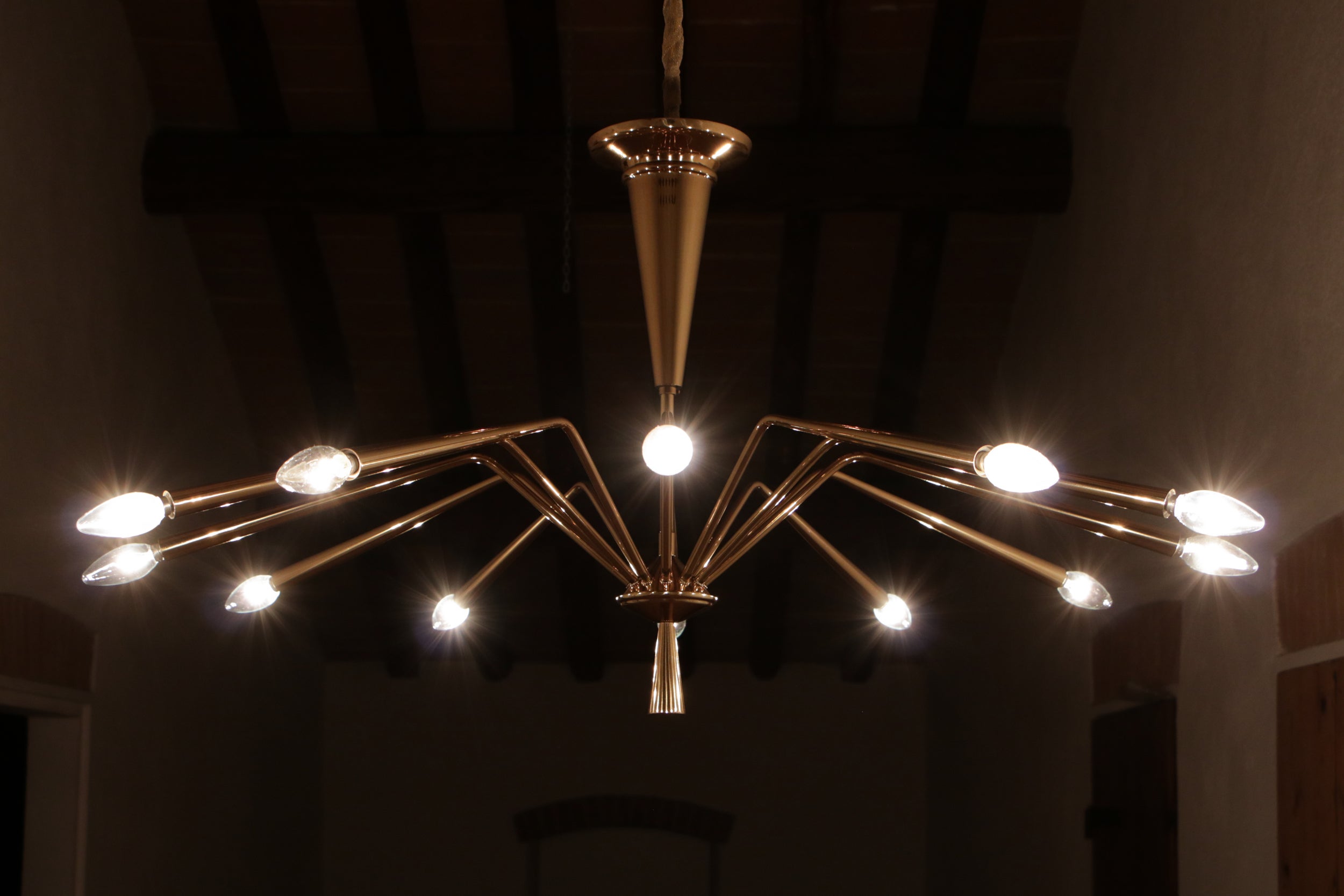 Magnifico lampadario moderno di metà secolo di Oscar Torlasco per Lumi Milano, modello 234, degli anni '50, Italia. La struttura è interamente realizzata in ottone lucido. Questo lampadario ha dodici luci in formato E14. Ti consigliamo di