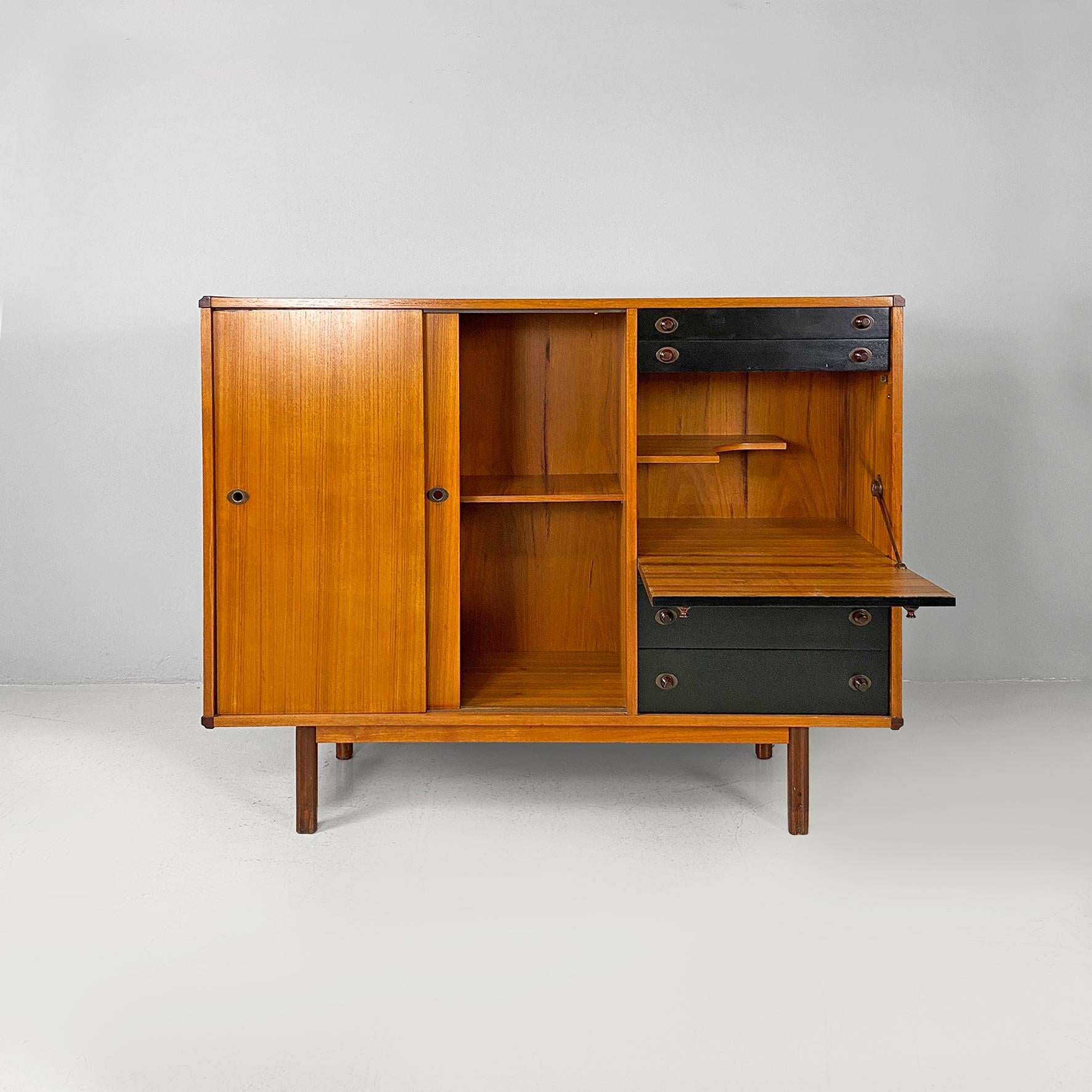 Italian mid-century modern two-tone wood highboard, 1960s
Highboard or tall sideboard with a two-tone wooden structure, with sliding doors on the left side and black drawers on the right side. On the right side there is also a drop-down door,
