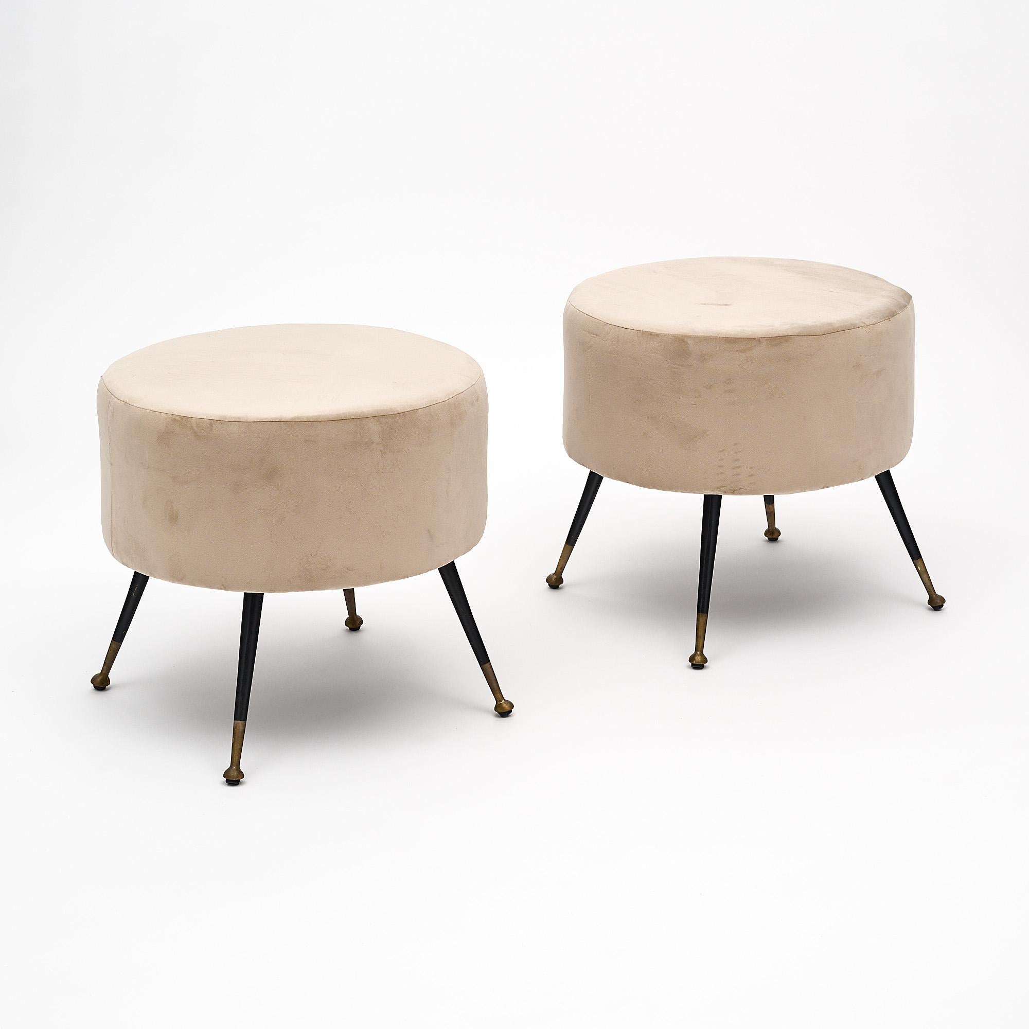 Pair of Italian mid- century Modern stools newly upholstered with an taupe colored micro fiber. Four original tapered black lacquered steel legs with brass feet.