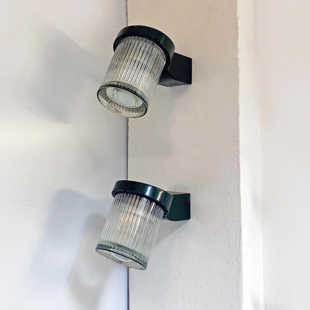 Italian Mid-Century Modern wall lights by Angelo Mangiarotti for Artemide, 1960s
Pair of wall lamp with metal structure in dark green with thick glass lampshade and embossed brand. Designed by Angelo Mangiarotti for Artemide.

Excellent