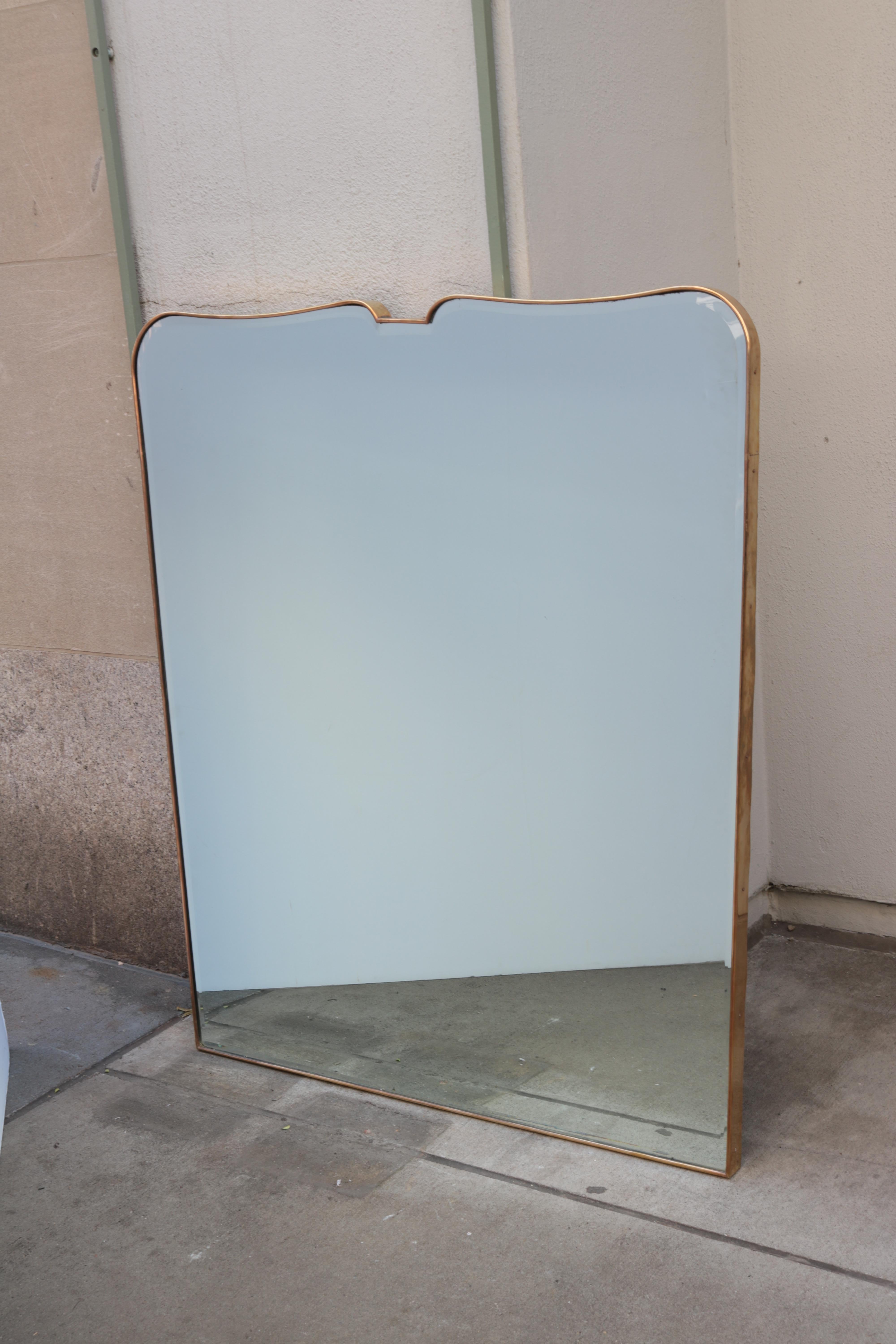 An Italian Mid-Century Modernist wall mirror. 
Brass frame with original beveled edge mirror.