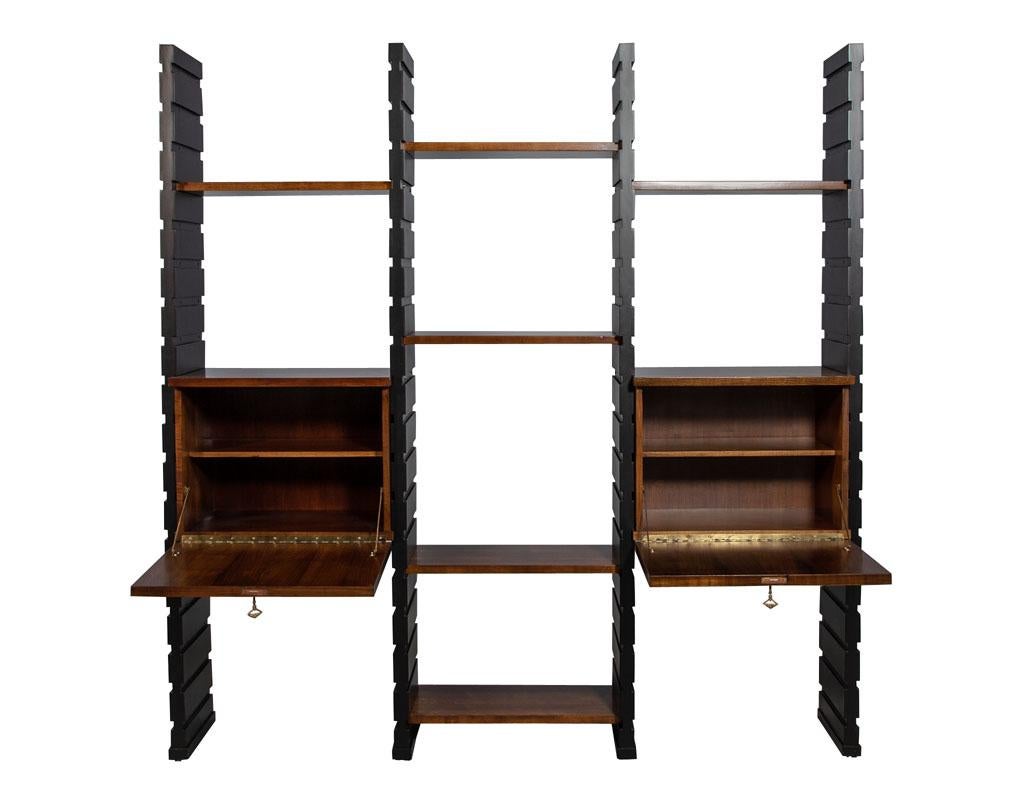 Italian Mid-Century Modern wall unit étagère. Masterfully restored by the Carrocel artisans in a satin black lacquer and natural walnut wood tone shelving. This piece is fully adjustable to your needs.

Price includes complimentary curb side