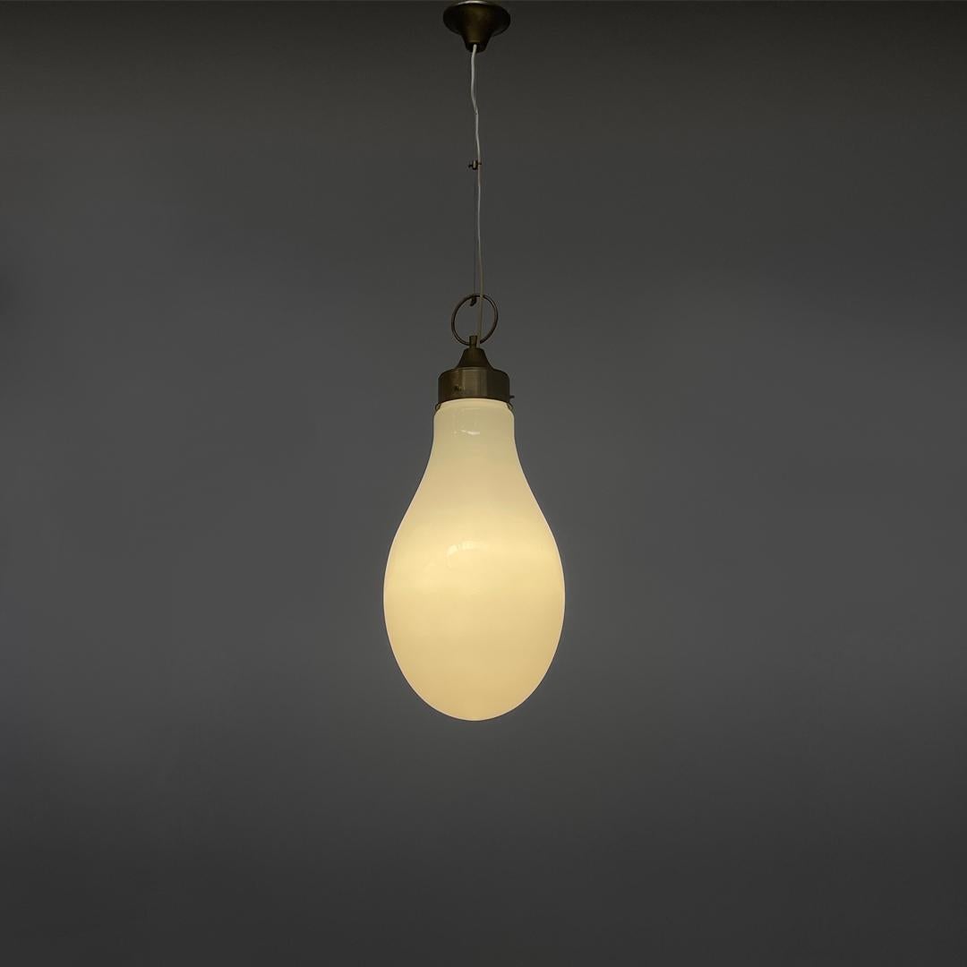 Italian mid-century modern white glass chandelier by Carlo Nason, 1960s
Round base chandelier. The lampshade is an elongated oval shape in white glass, which narrows towards the metal base.
A metal wire and a white plastic cable are connected to the
