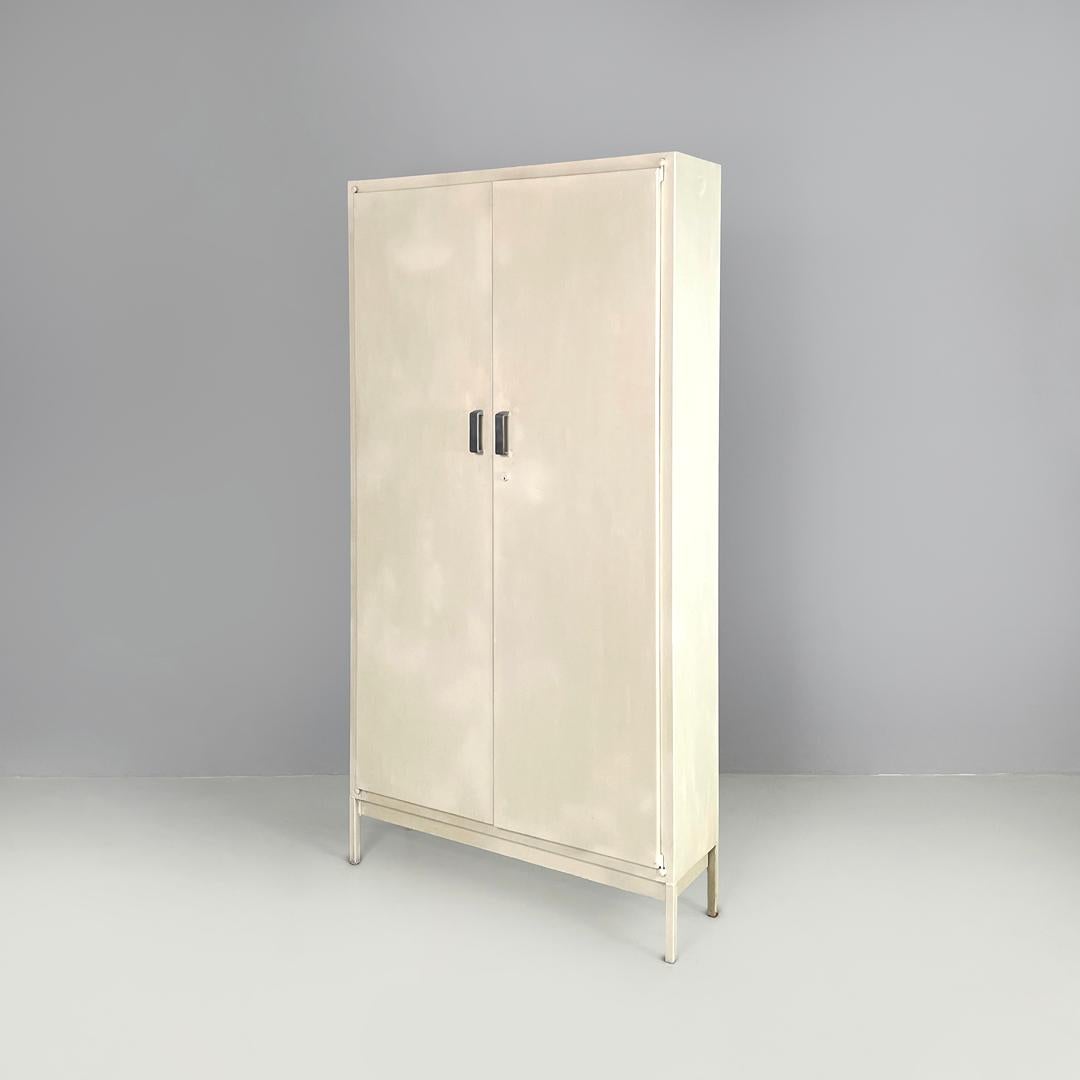 Italian mid-century modern white industrial bathroom two doors cabinet, 1960s
Industrial wardrobe in white painted metal. It has two doors with metal handles, inside there are five doors that can be arranged as desired thanks to metal dowels that
