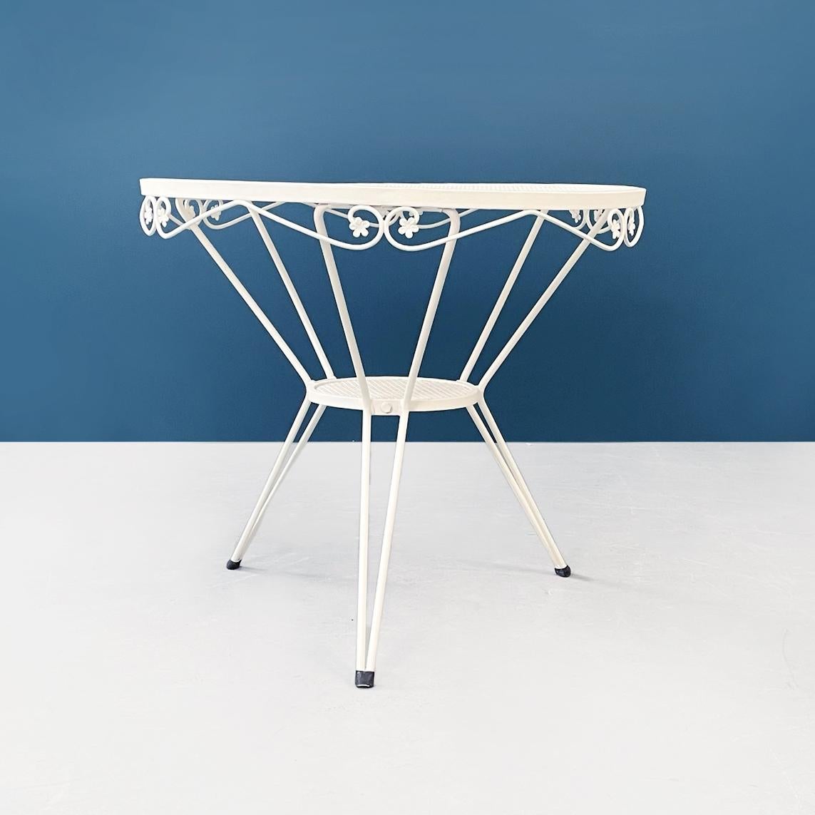 Italian Mid-Century Modern White iron garden round table with flower decor, 1960s.
Garden table in white painted iron with perforated round top. The edge of the top is finely worked with floral decorations and curls. Under the main top there is a