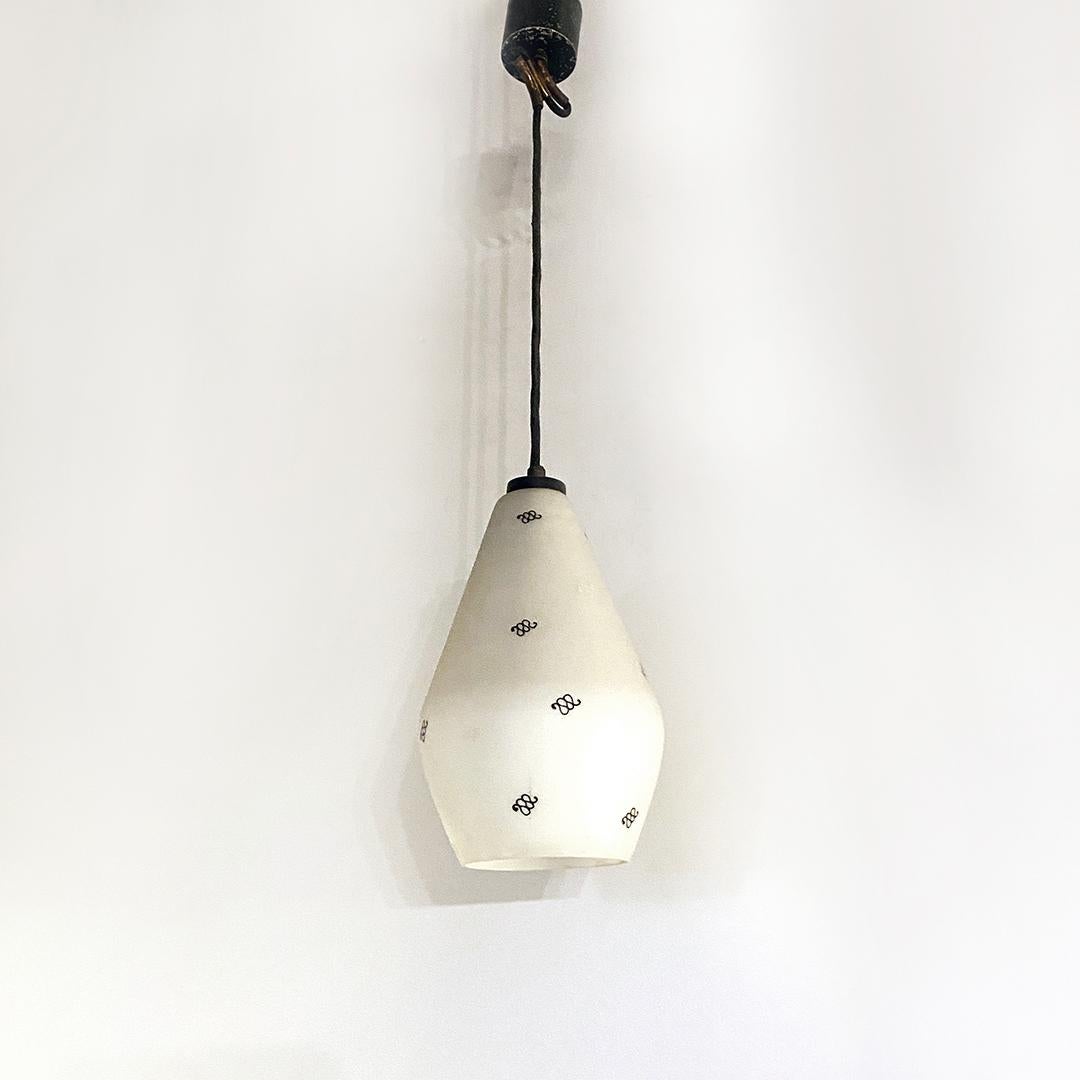 Italian Mid-Century Modern white opaline glass chandelier with motif, 1950s
White opaline glass chandelier with a recurring black decorative motif and brass detail in the shape of an 