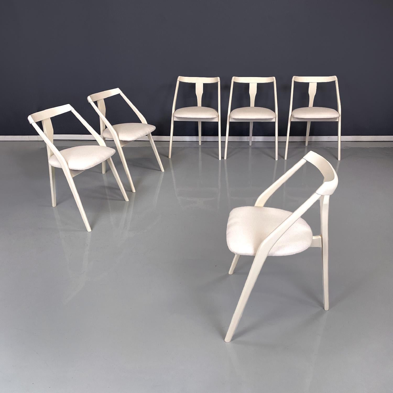 Italian mid-century modern white wood and fabric chairs, 1960s
Set of six chairs with white lacquered wooden structure with matt finish. The seat is rounded and covered in white fabric, the backrest is made up of a rectangular section strip that