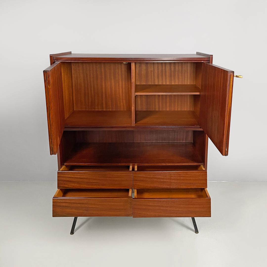 Italian mid-century modern wood and brass highboard with doors and drawers 1960s
Highboard or wooden sideboard. In the upper part of the structure there are two doors with a working brass key that open onto an internal compartment divided into two