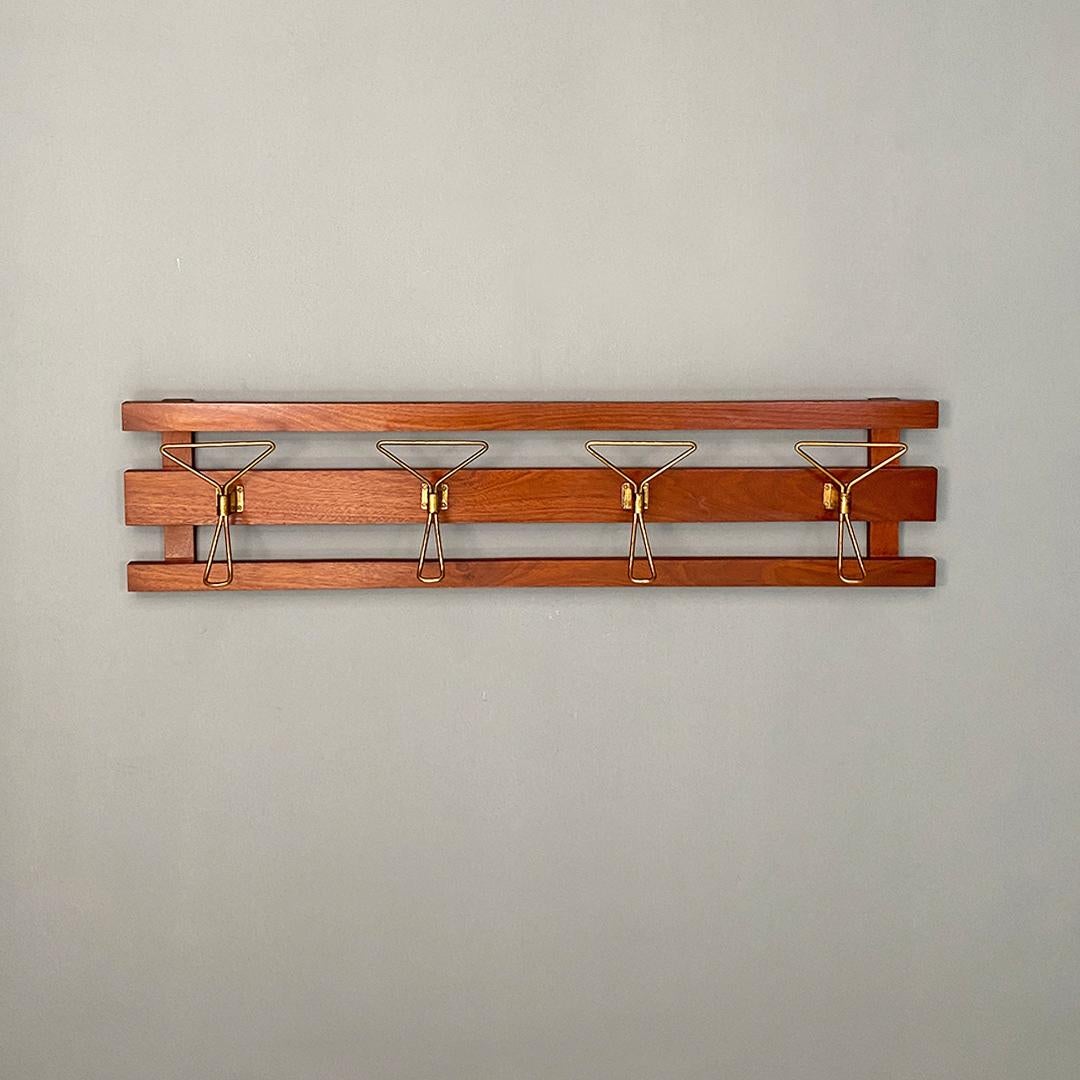 Italian Mid-Century Modern wooden slats structure and four brass hooks wall coat hanger.
Elegant wall coat hanger, with four brass hooks with wooden slats structure,
with a typical mid-century and sixties design.
Even the screws and the