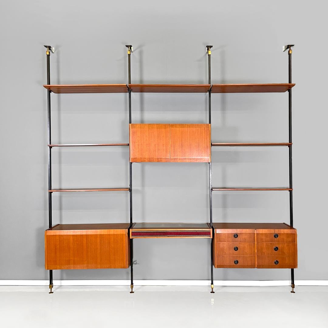 Italian mid-century modern wood and metal floor-to-ceiling bookcase, 1960s
Wall floor-to-ceiling bookcase in wood and black metal. The supporting structure is made up of three square section uprights, there is a flap cabinet, a hinged cabinet, a