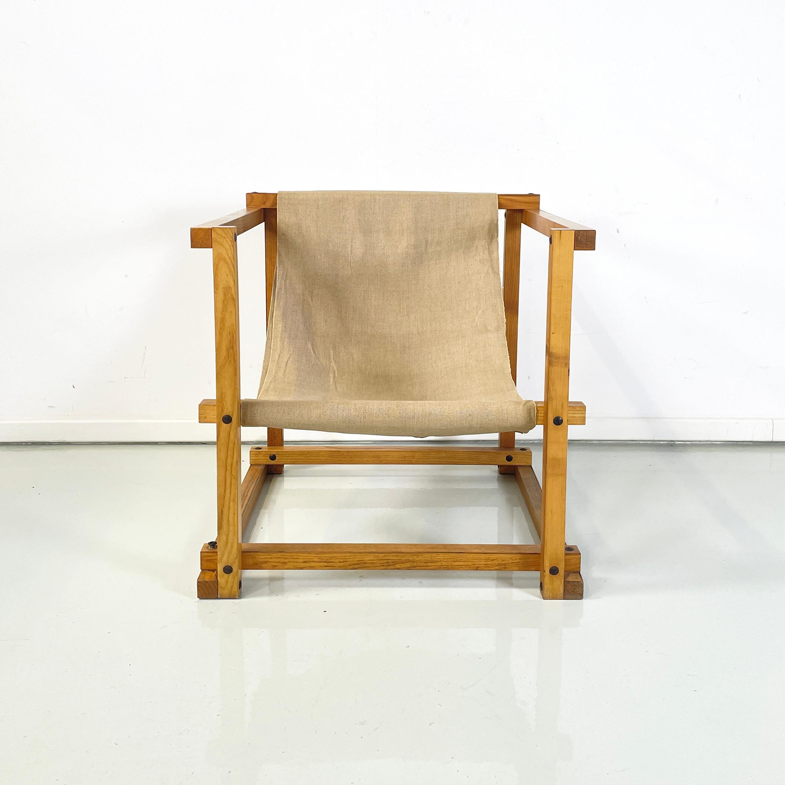 Italian mid-century modern Wood armchair with beige fabric by Pino Pedano, 1970s
Armchair with cubic shape, made up of several wooden slats with a square section, joined at the vertices by metal inserts. The seat and back of the chair are made of a