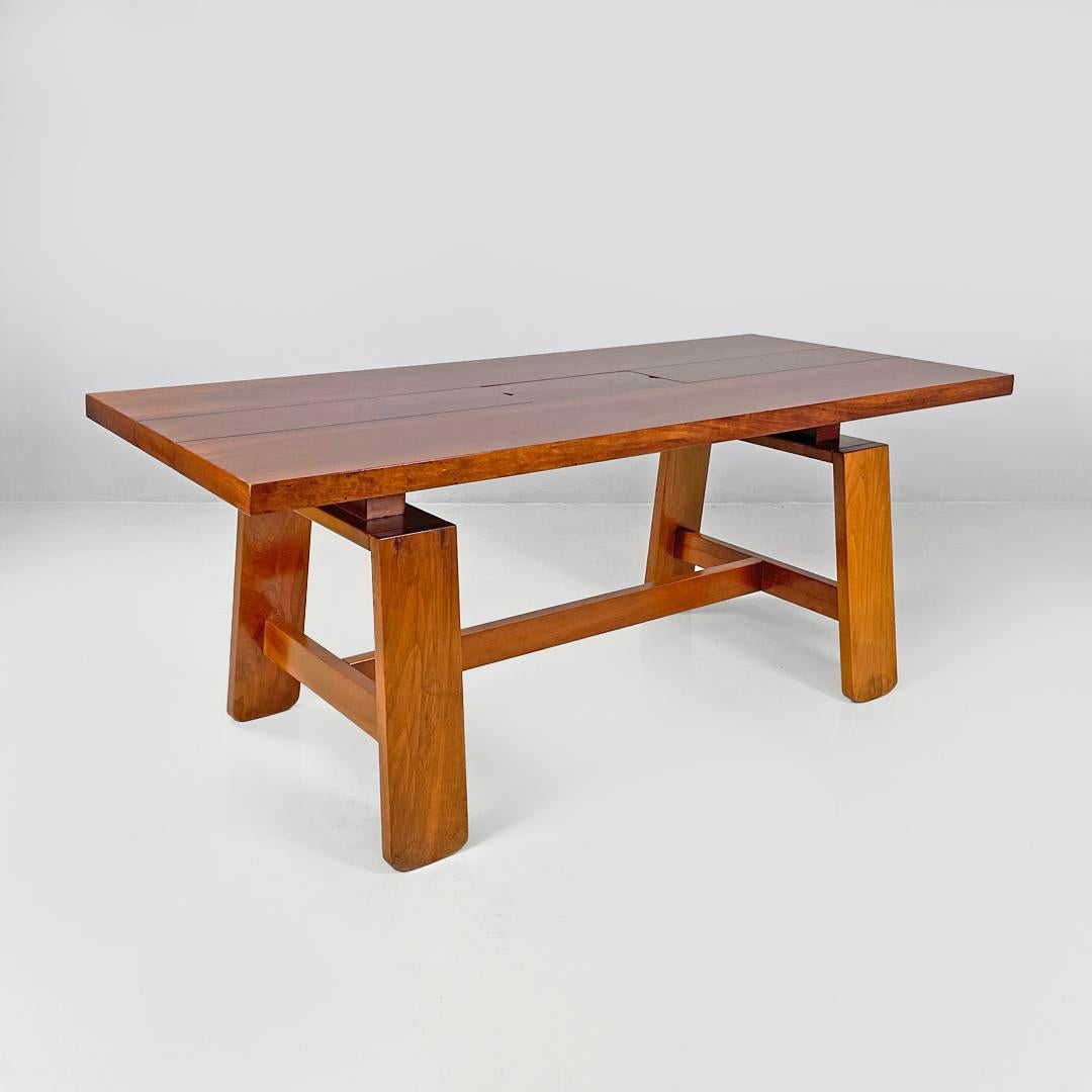 Italian mid-century modern wood dining table 611 by Coppola for Bernini, 1960s
Dining table mod. 611 entirely in wood. The rectangular top has an opening in the center which corresponds to a wooden 