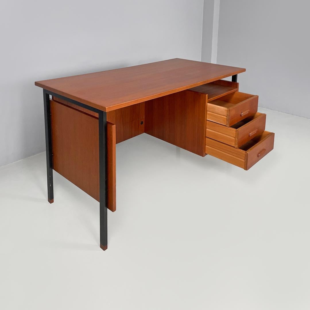Italian mid-century modern wooden and black metal desk with three drawers, 1960s
Wooden desk with drawers. The top is rectangular, under the top on the right are three drawers with elongated handles also in wood. On the sides and on the back there