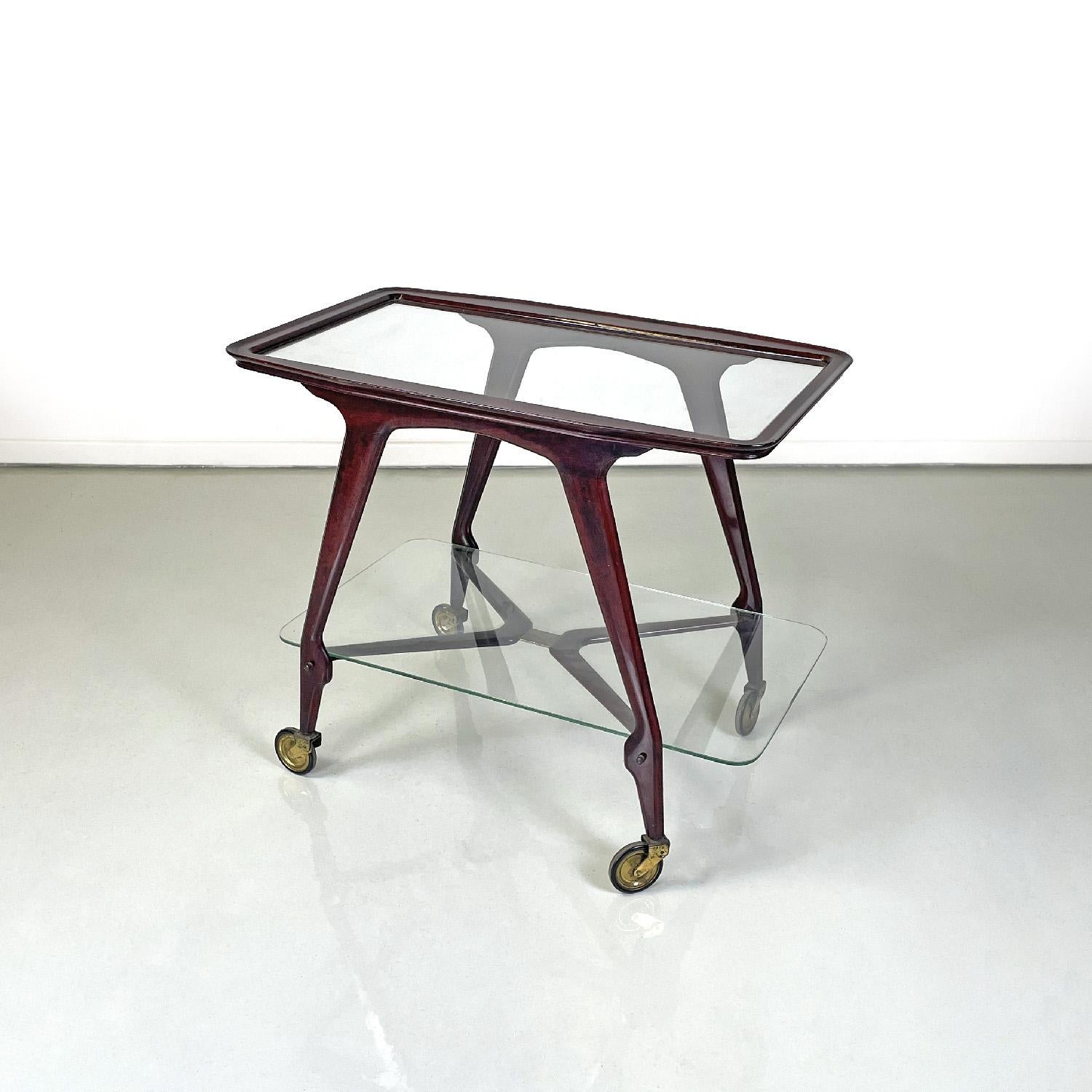 Italian mid-century modern wooden cart two glass tops and brass wheels, 1950s
Cart with two rectangular shelves. The structure of the cart is made of wood, the upper surface is externally made of wood while the internal part is made of glass. The