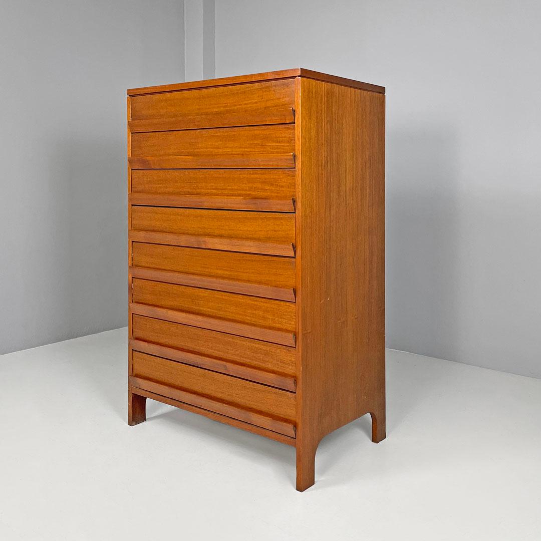 Italian mid-century modern wooden chest of drawers, 1960s
Rectangular chest of drawers entirely made of wood. On the front it has eight drawers, the handle is given by a shaped wooden strip of the same length as the drawer. The legs are made from