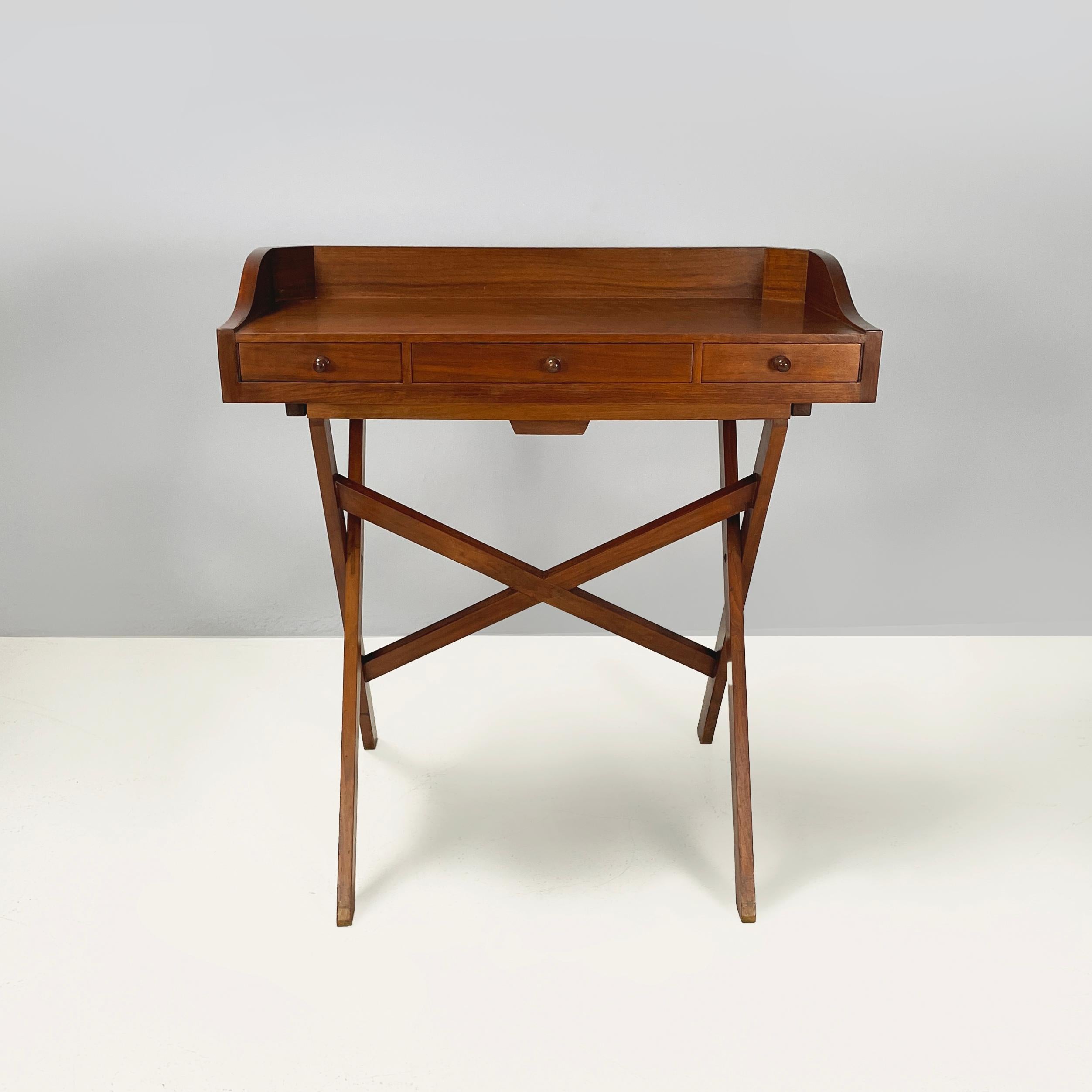 Italian mid-century modern Wooden desk with drawers and retractable shelf, 1960s
Desk entirely in wood. The shaped top has raised sides and 3 rectangular drawers with spherical handles. Furthermore, the desk features a retractable shelf. The slat