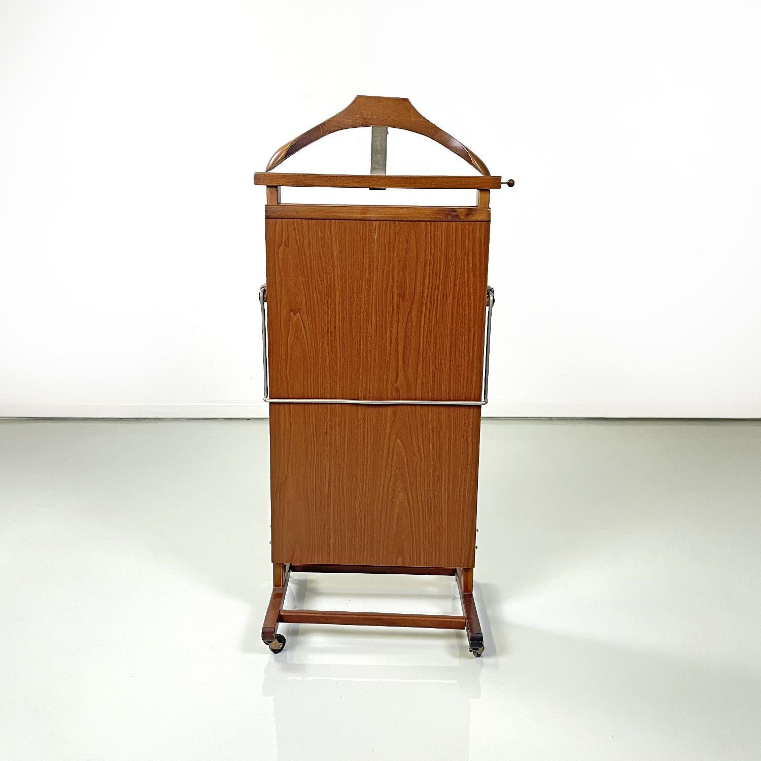 Italian mid-century modern wooden valet stand by Fratelli Reguitti, 1960s
Wooden valet stand or clothes hangers with rectangular base. The main structure is rectangular and on one side has a top of the same size which opens and locks thanks to a