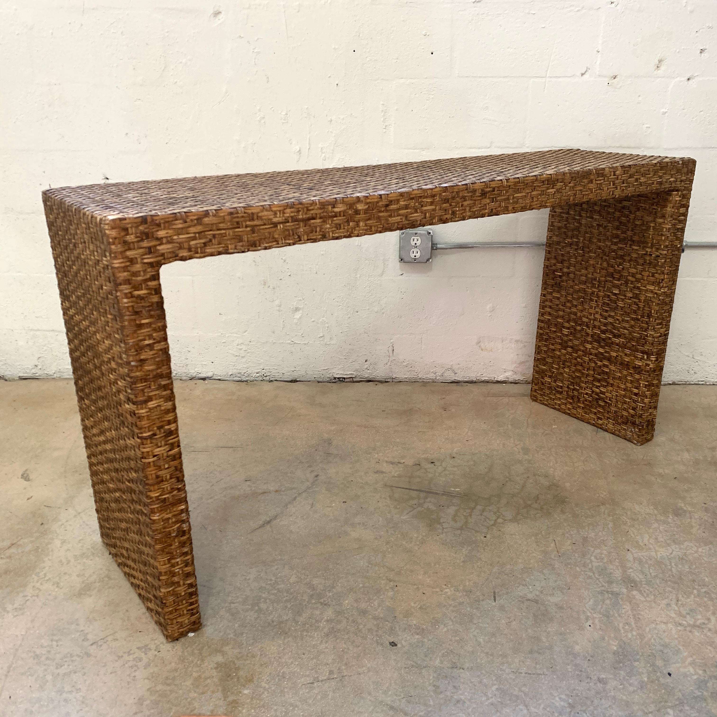 Versatile Parsons design waterfall console rendered in woven wicker finished on all sides, Italy, 1970s.