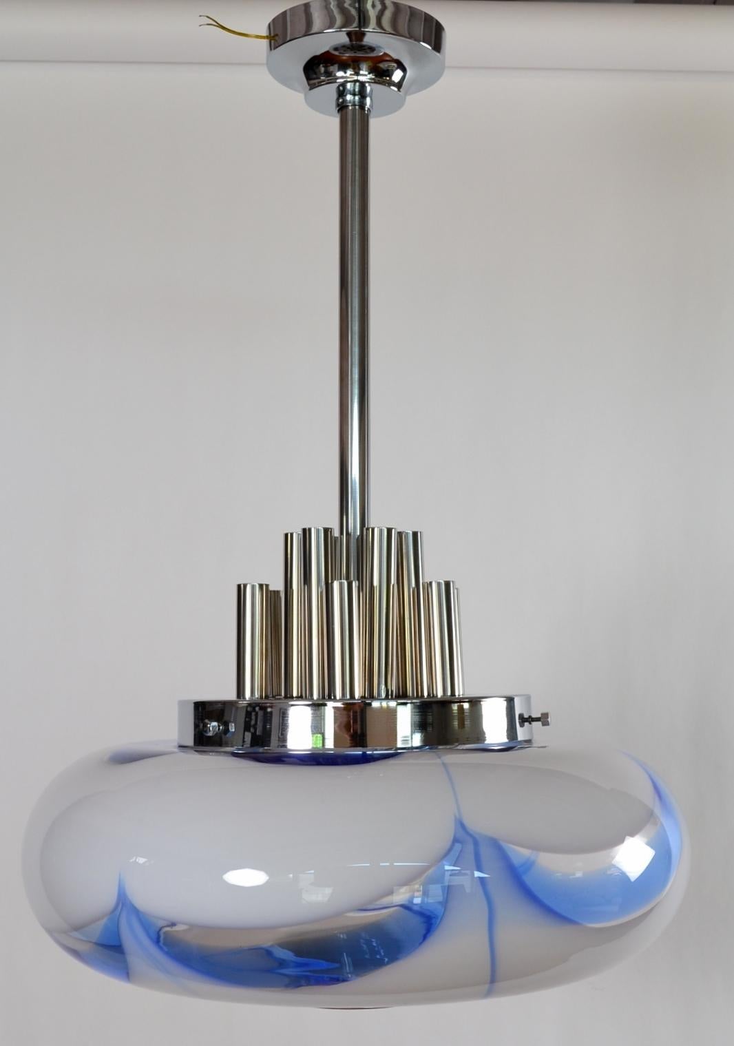 Gorgeous and large hand blown pendant lamp with sky-blue and white crystal glass sphere produced in Murano, Italy during the 1970s.
The big Murano glass in shiny white and blue is beautiful when illuminated and leaves magic effects in every