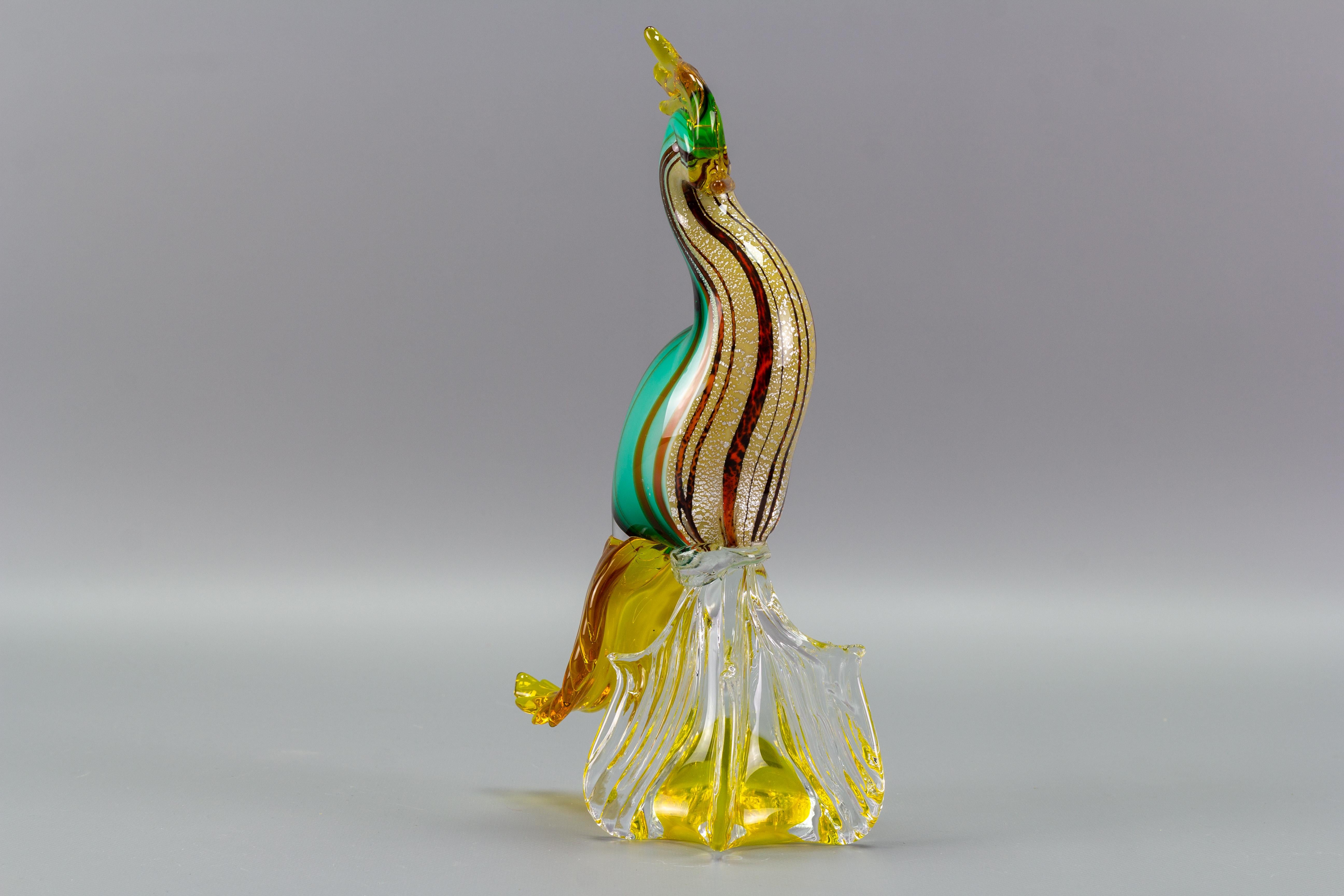 Gorgeous Italian hand-blown murano glass paradise bird sculpture in green, yellow, amber, and light green colors. Beautifully sculpted and profusely filled with silver melts and selenium glass proportion. Italy, the 1960s.
Dimensions: height: 30 cm