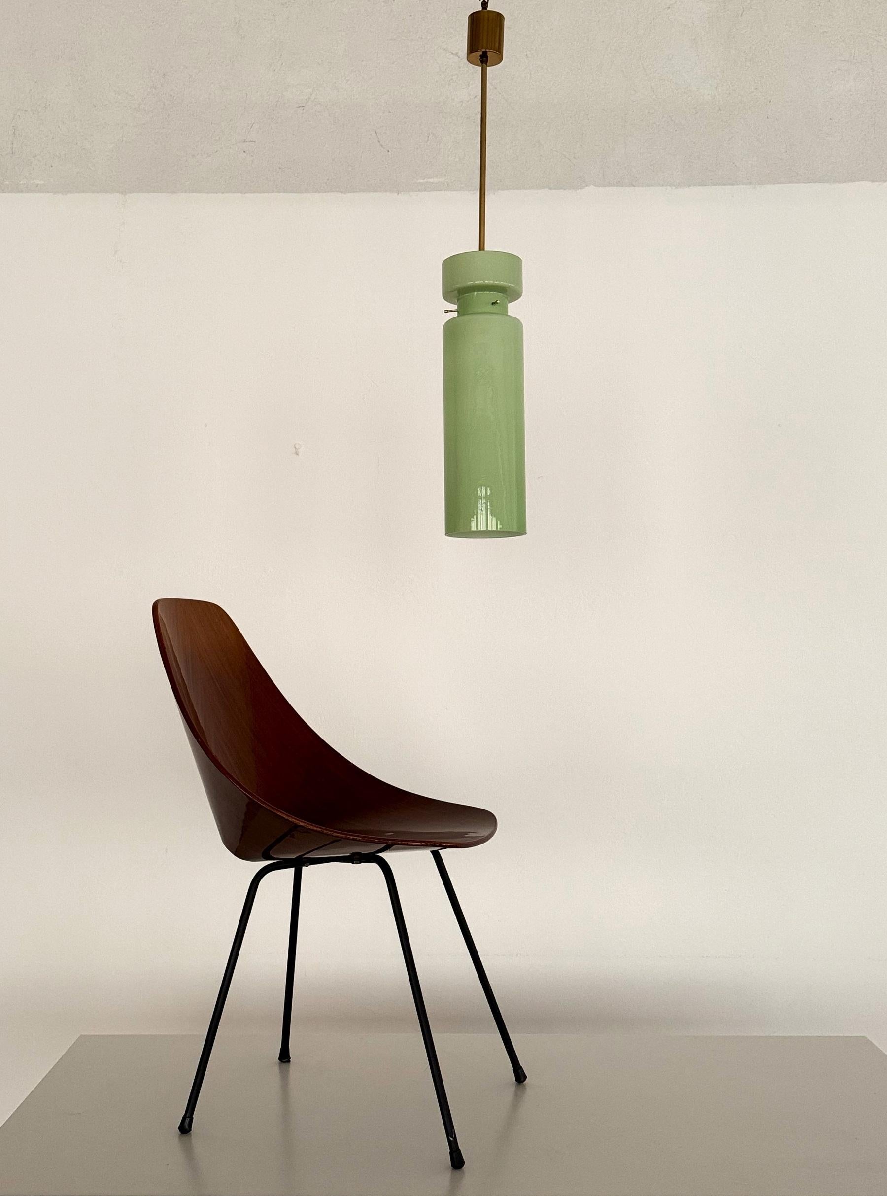 Beautiful glass pendant light hand-crafted of kiwi green Murano glass and brass hanging bar and ceiling rose. Unusual glass form.
Made in the 1970s/1980s by Vistosi, Murano, Italy.
The glass has 2 layers : outside kiwi-green and inside a light white