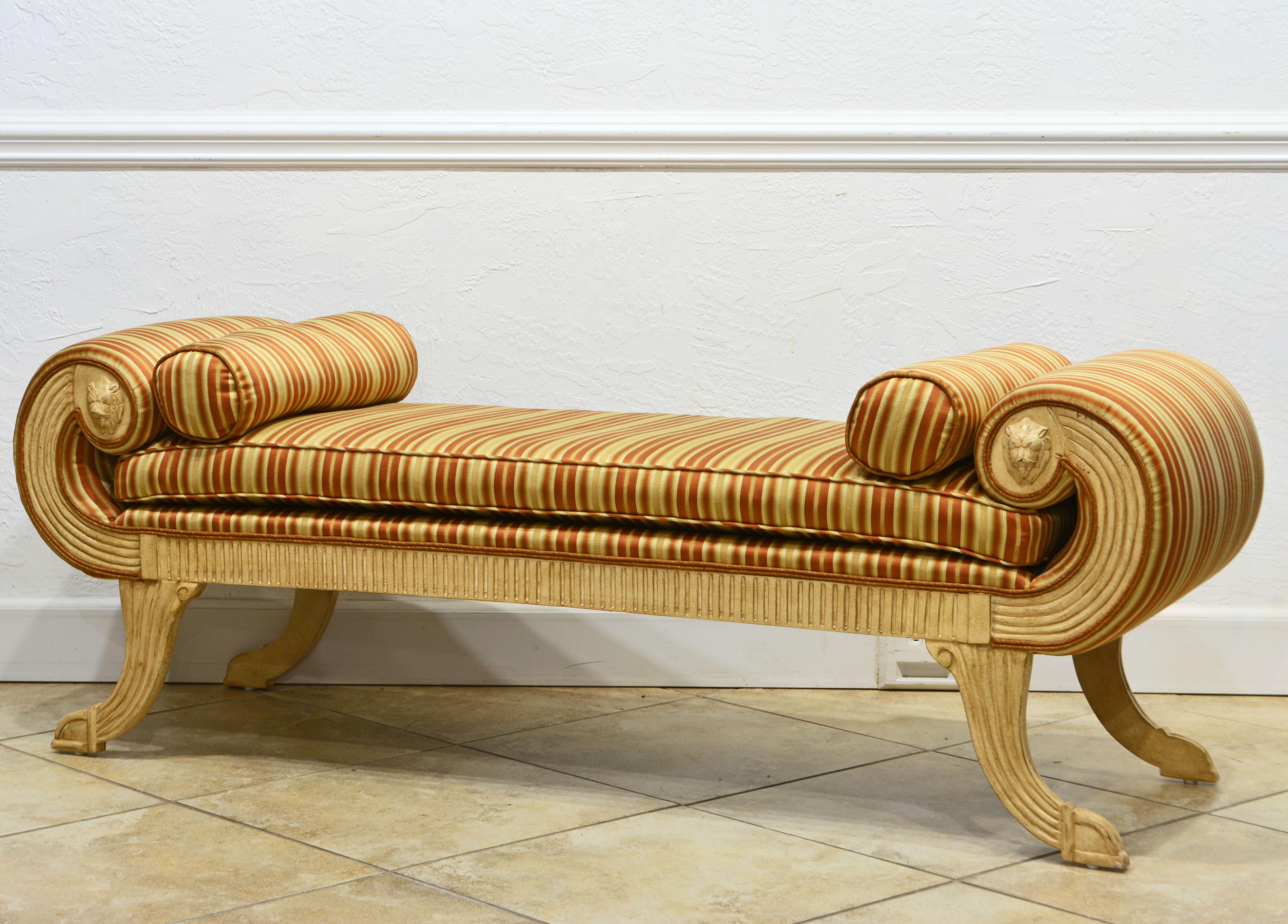 This distinguished neoclassical daybed with beautiful upholstery likely dates to the 1960's. It features an ivory white painted and reeded frame fashioned in the neoclassical or empire style and accented by carved lion's heads.