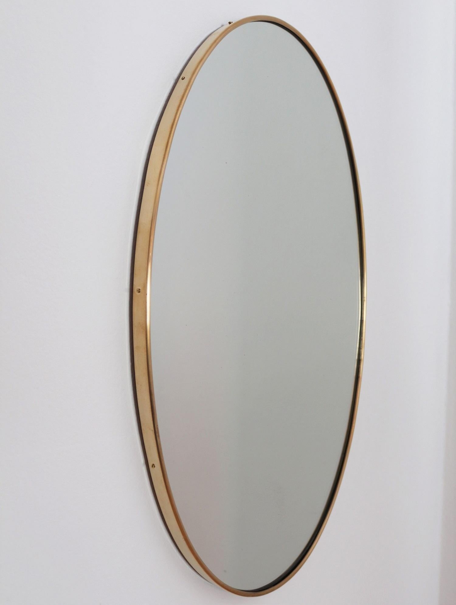 Beautiful Italian midcentury wall mirror with original brass frame.
Made in Italy in the 1950s.
The wall mirror is completely in original, cleaned condition. 
On the mirror glass are some light normal vintage spots, almost not seen when the