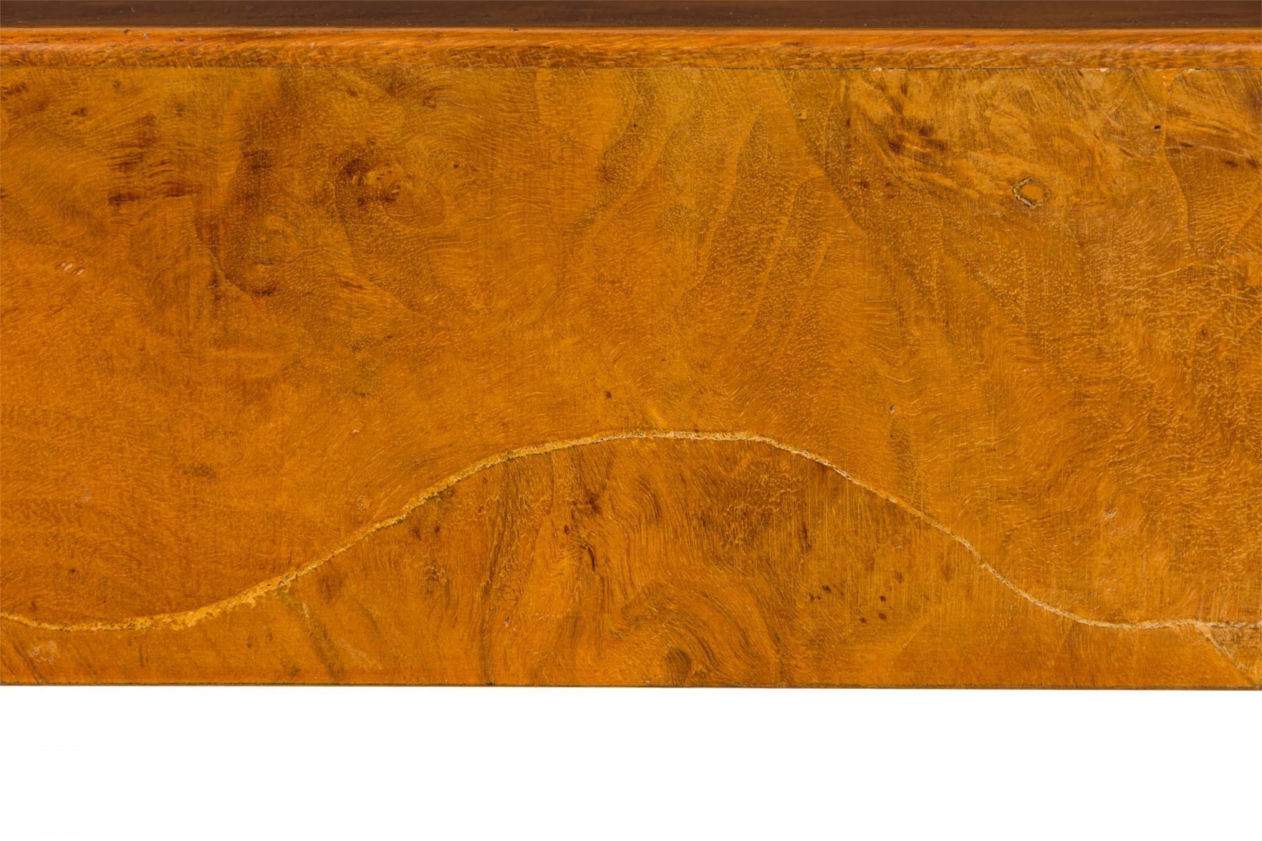 Italian Mid-Century console table with a rectangular top containing three small drawers along the front, resting on four triangular legs and finished in oyster burl veneer.

Slight cracking to oyster burl veneer and wood on the edge of all three