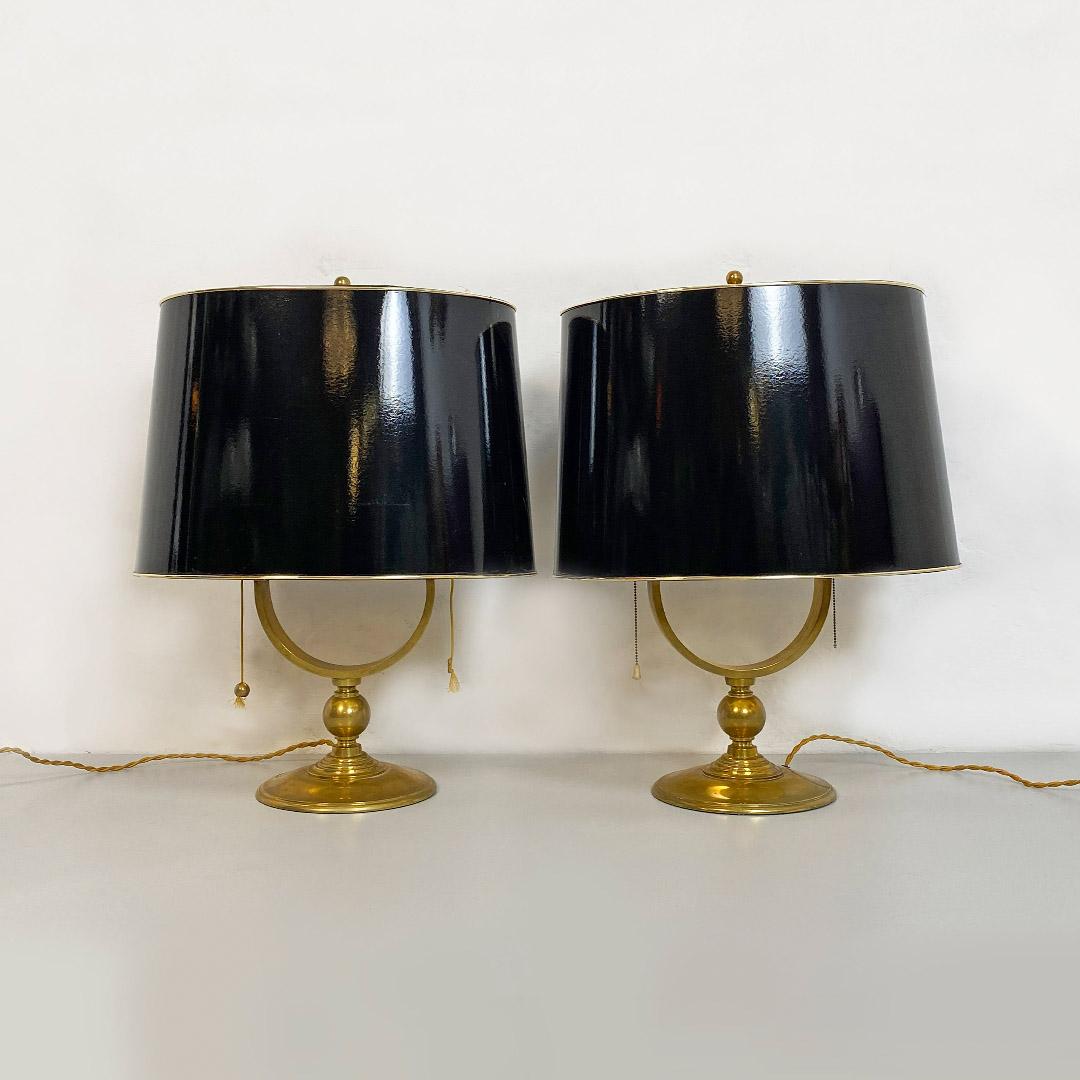 Italian Mid-Century Modern pair of brass table lamp with glossy black lampshade, 1940s
Pair of two lampshades with solid brass structure and elliptical lampshade, glossy black on the outside and gilded on the inside, with a gold border.
Ignition