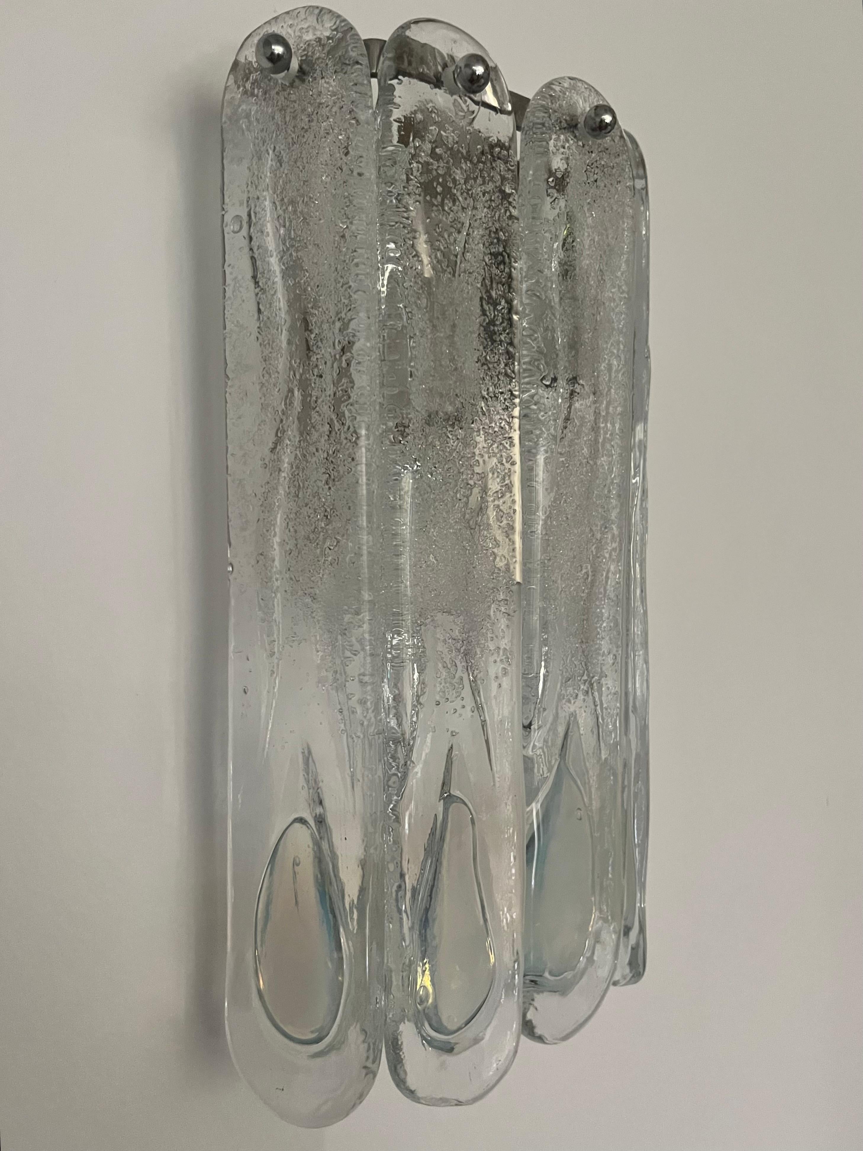 Stunning and beauty Pair of Italian Iridescent Murano glass Wall Sconces. These fixtures were designed and manufactured during the 1970s in Italy by Mazzega.
Each Sconce is equipped with two light sockets E14. A professional electrician has checked