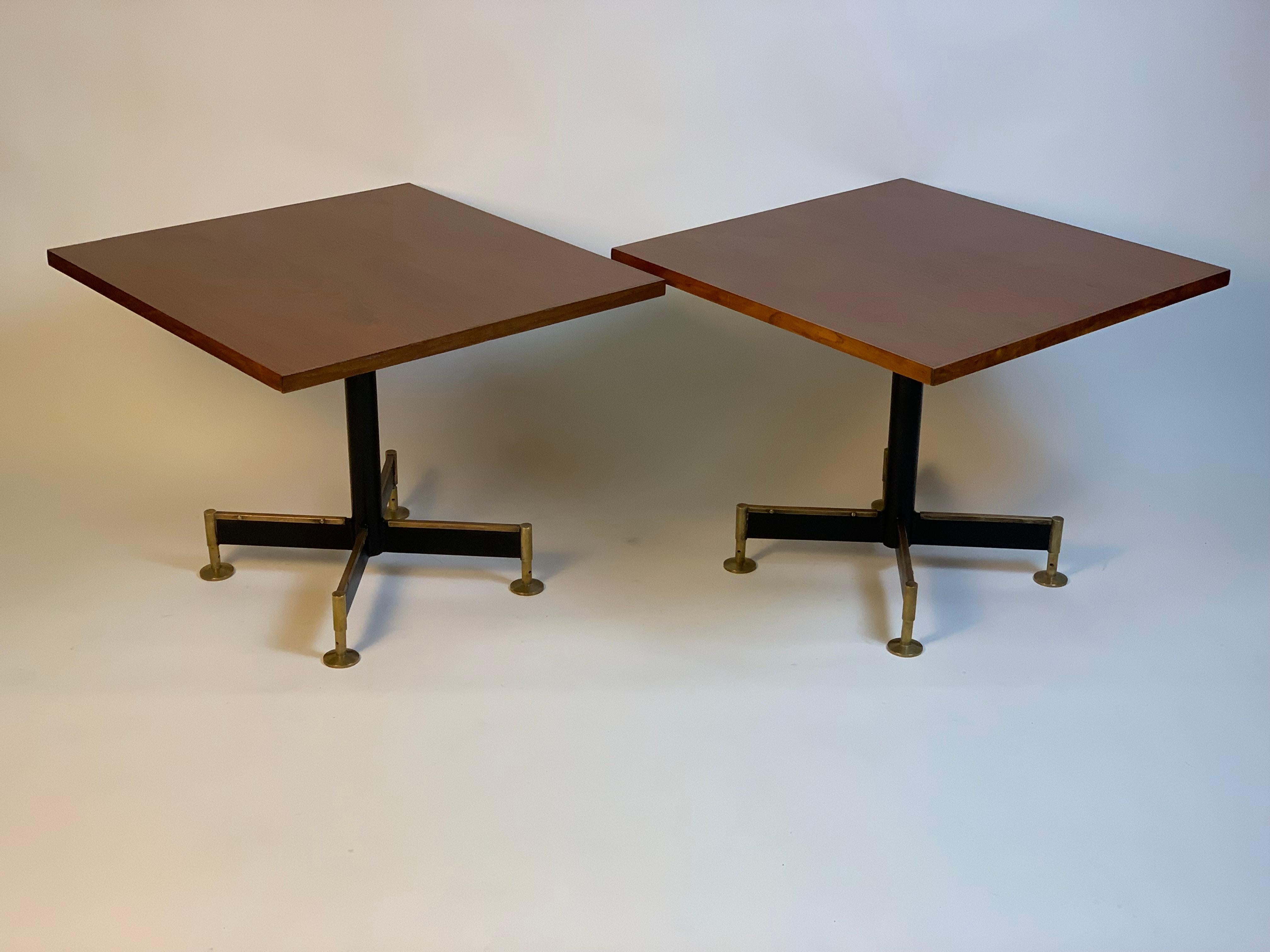 Pair of Italian coffee tables from the 1960s Mid Century Modern, the base is made up of four black lacquered iron elements with brass details, circular brass feet.
The table tops are square.
It is rare to find pairs of tables to be placed next to