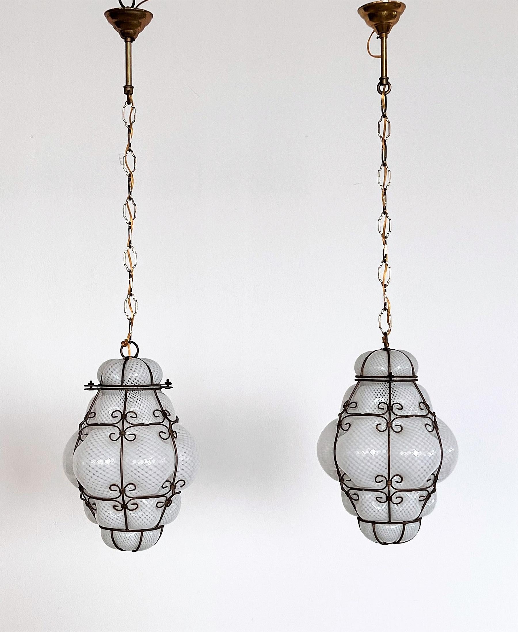 Wonderful pair of Venetian lanterns, which were handmade during the 1950s at Venini in Murano. 
The pure white 