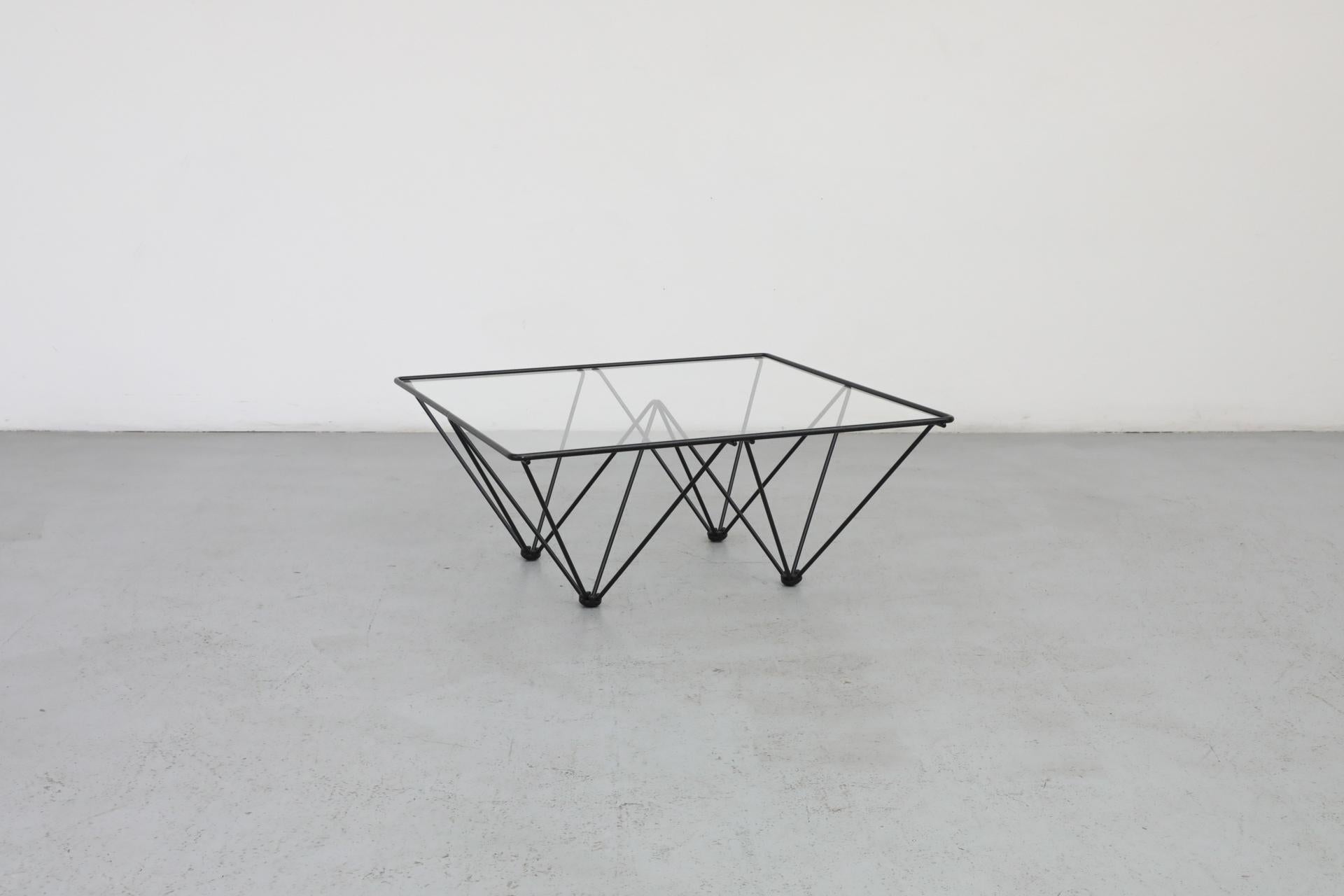 Italian Mid-Century square glass coffee table with black architectural pyramid frame. Designed in the style of the 