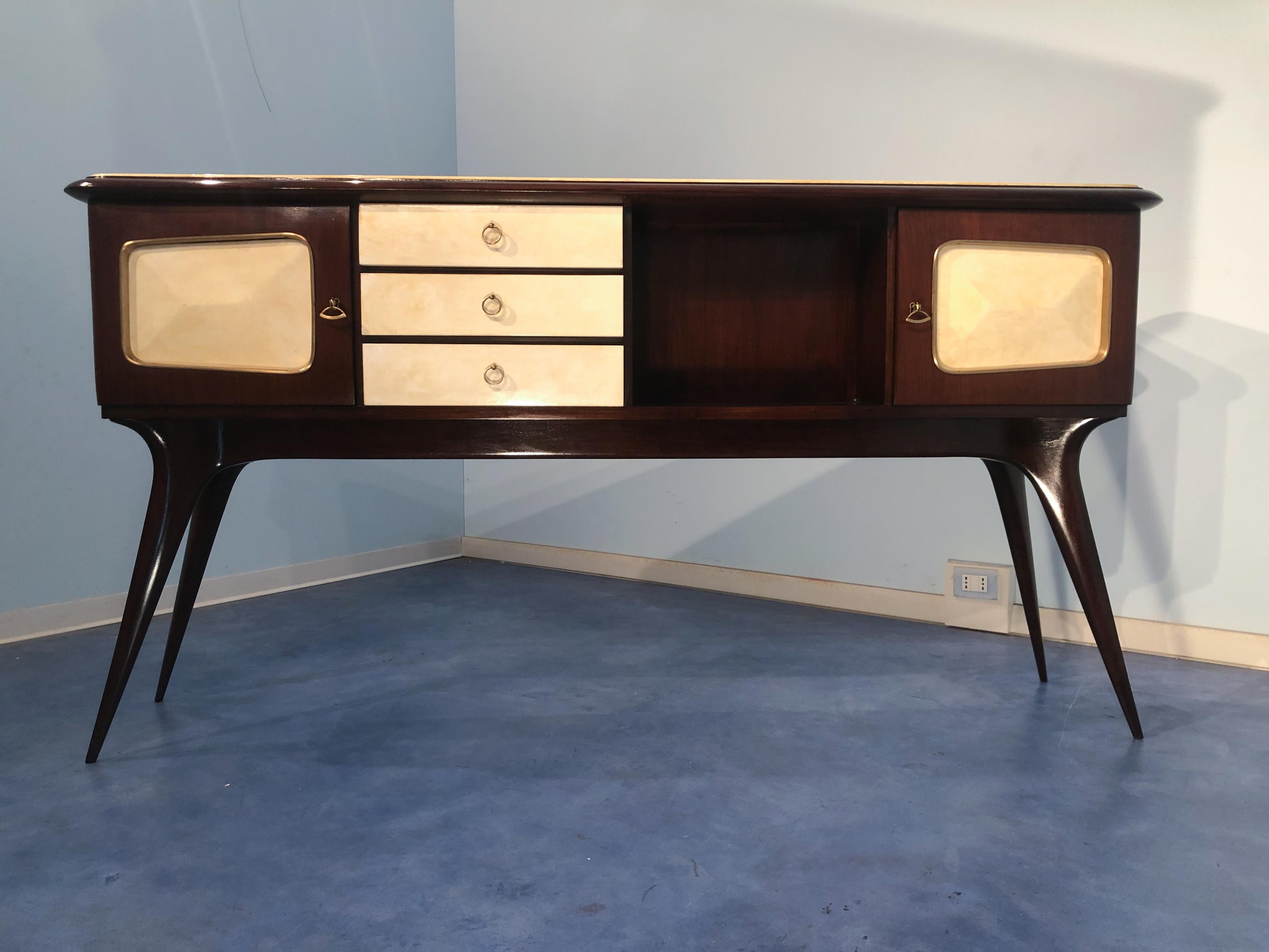 Stilysh Italian mid-century center sideboard, attributed to Guglielmo Ulrich produced in the 1950s. The sideboard is made of walnut and precious parchment paper. This piece is finished on both sides and can be used in the most varied ways. You can