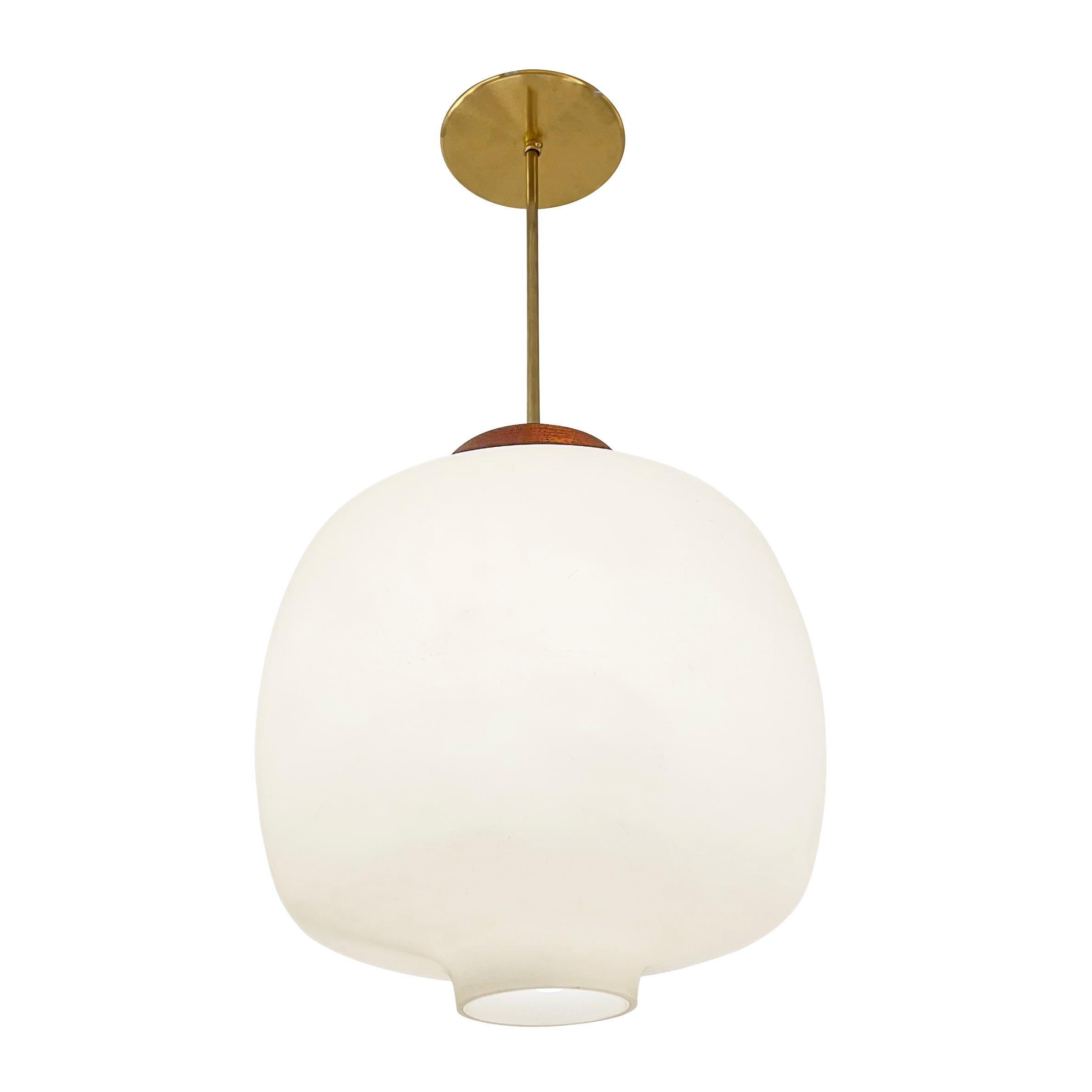 Italian midcentury pendant with a frosted glass shade, wood cap and brass stem and canopy. Designed by Angello Lelli for Arredoluce. Holds one E26 socket. Height of stem can be adjusted as needed

Condition: Good vintage condition, minor wear and