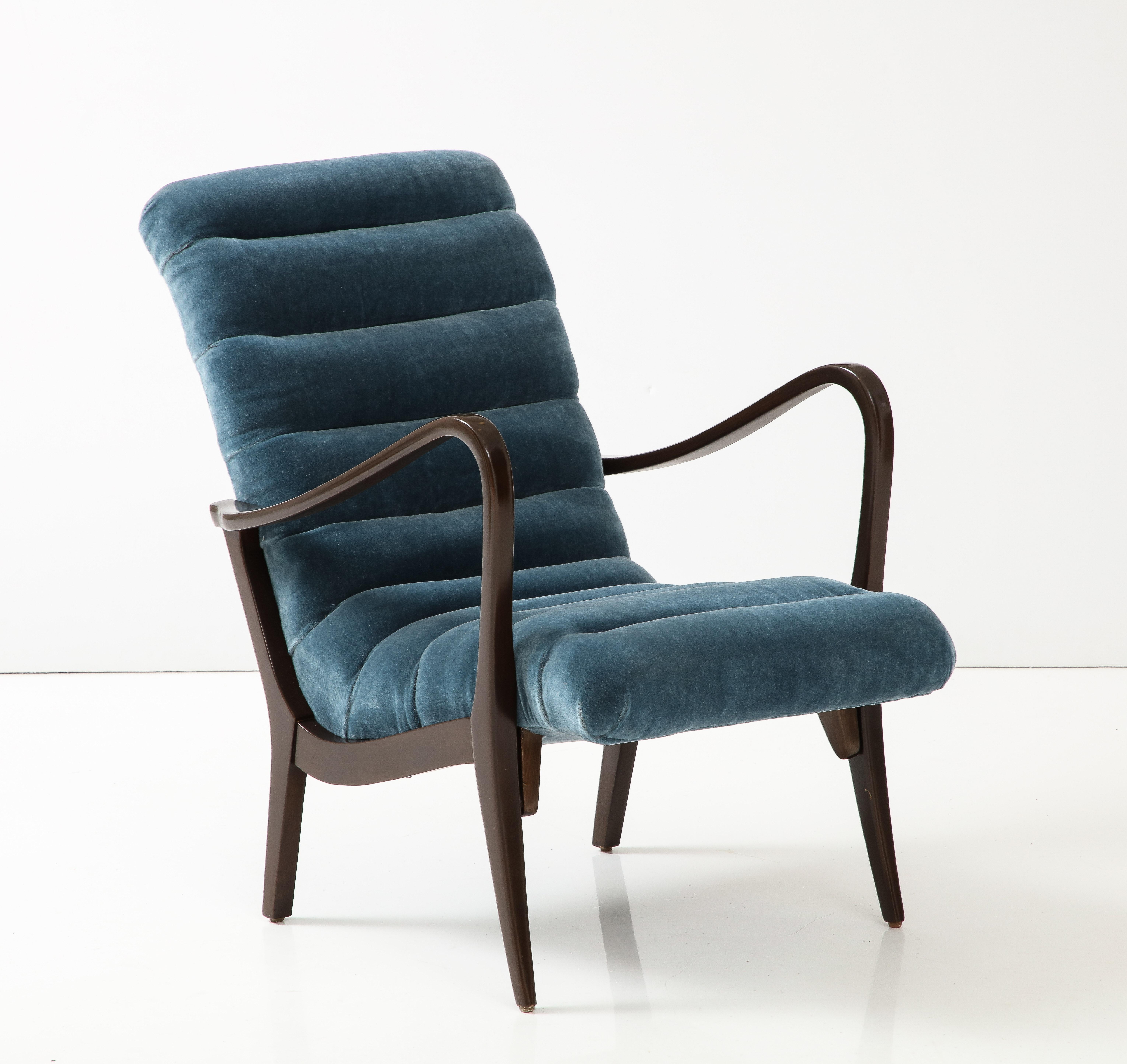 Italian Mid Century Modern lounge chair featuring sinuous arms and body hugging curved frame. Frame has been restored in a dark brown stain and upholstery has been updated in a Petrol Blue Mohair. 