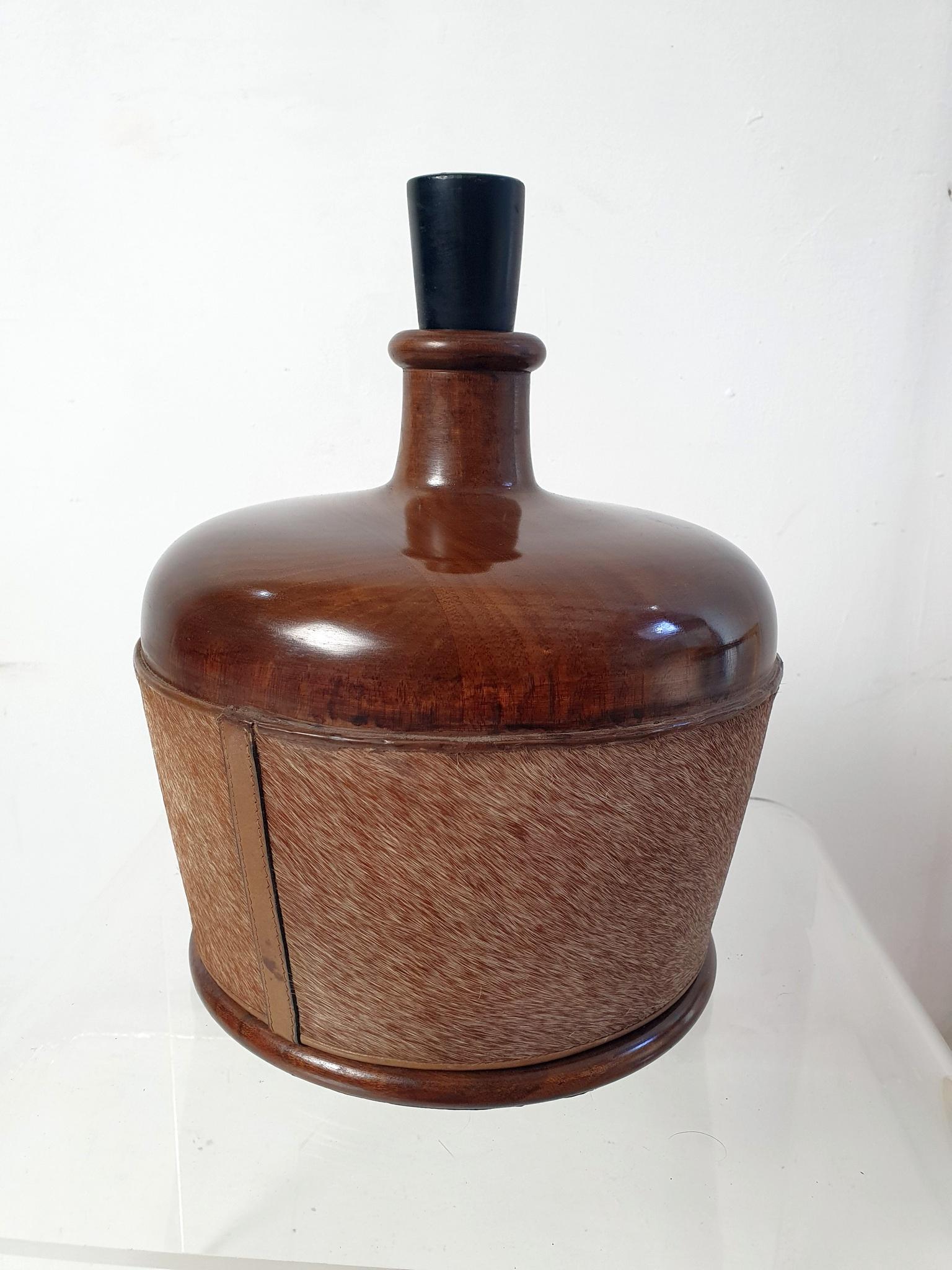 This rare item is designed as a bottle and hides a poker set inside and is a real collectors item. All chips and markers are in place as well as well as the original dice. The bottle is made in wood and decorated with cow hide. 
We had an exact