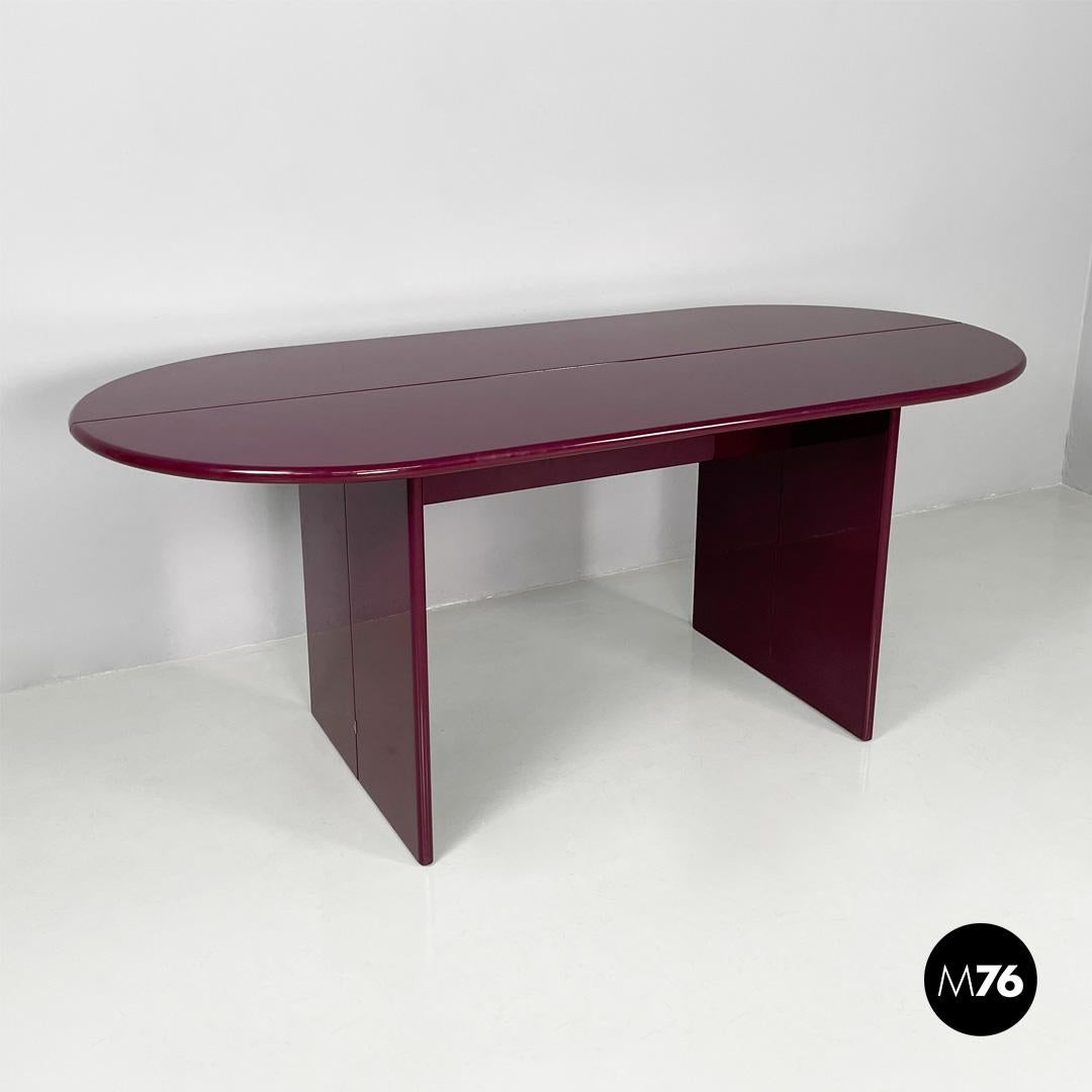 Italian mid century purple lacquered console table convertible, 1980s
Convertible console with oval top in purple lacquered wood.
The two semi-oval tops and the hinged elements allow the structure to be folded according to the available area.
It can