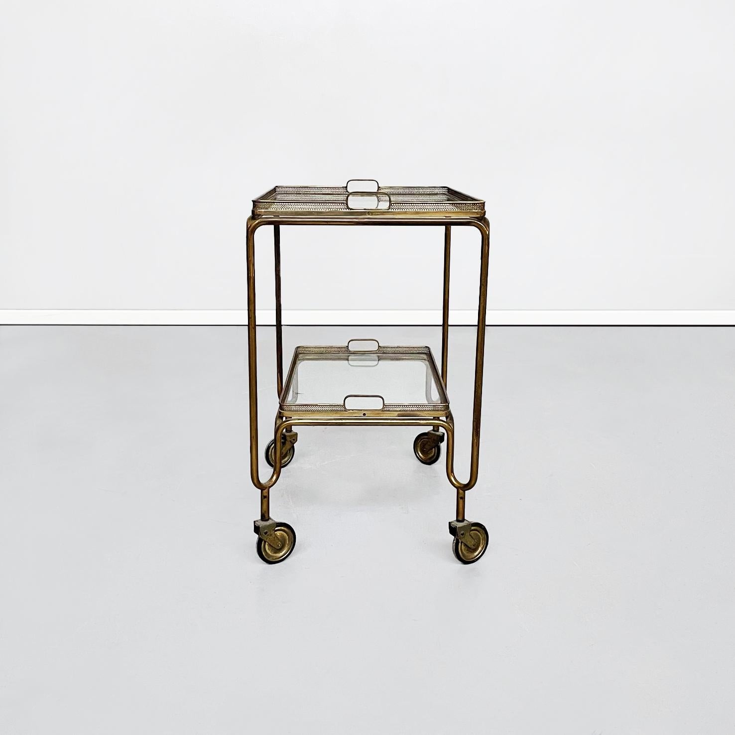 Italian mid-century rectangular bar cart in brass and glass, 1950s
Rectangular brass food trolley. The bar cart consists of two glass shelves and brass finely worked edges, these can be detached from the structure and used as trays. Each top has two