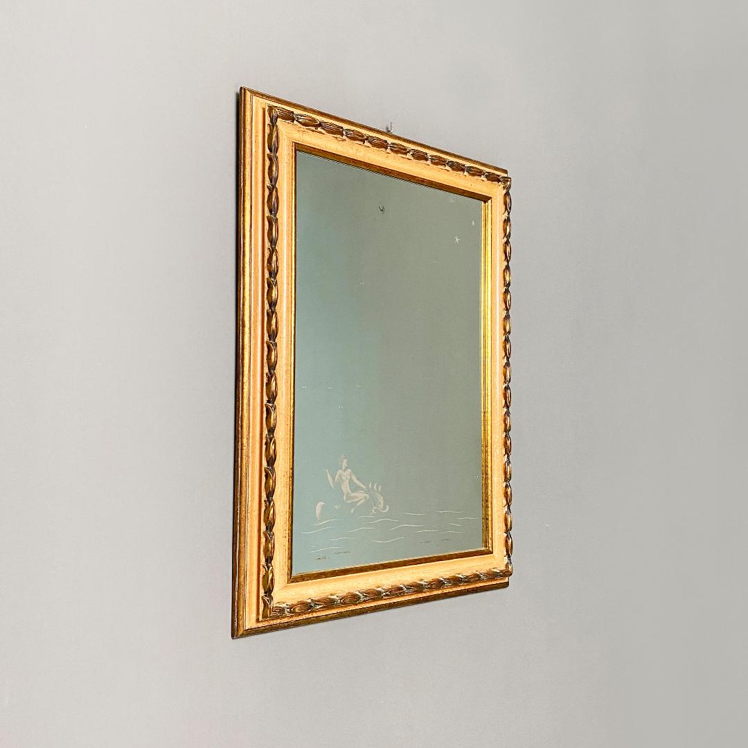 Italian mid-century modern rectangular mirror with lines drawn on the glass, in the style of Gio Ponti, 1940s.
Rectangular mirror, with Pontian lines drawing on the glass. White design on the lower part depicting a stylized marine scene, with two