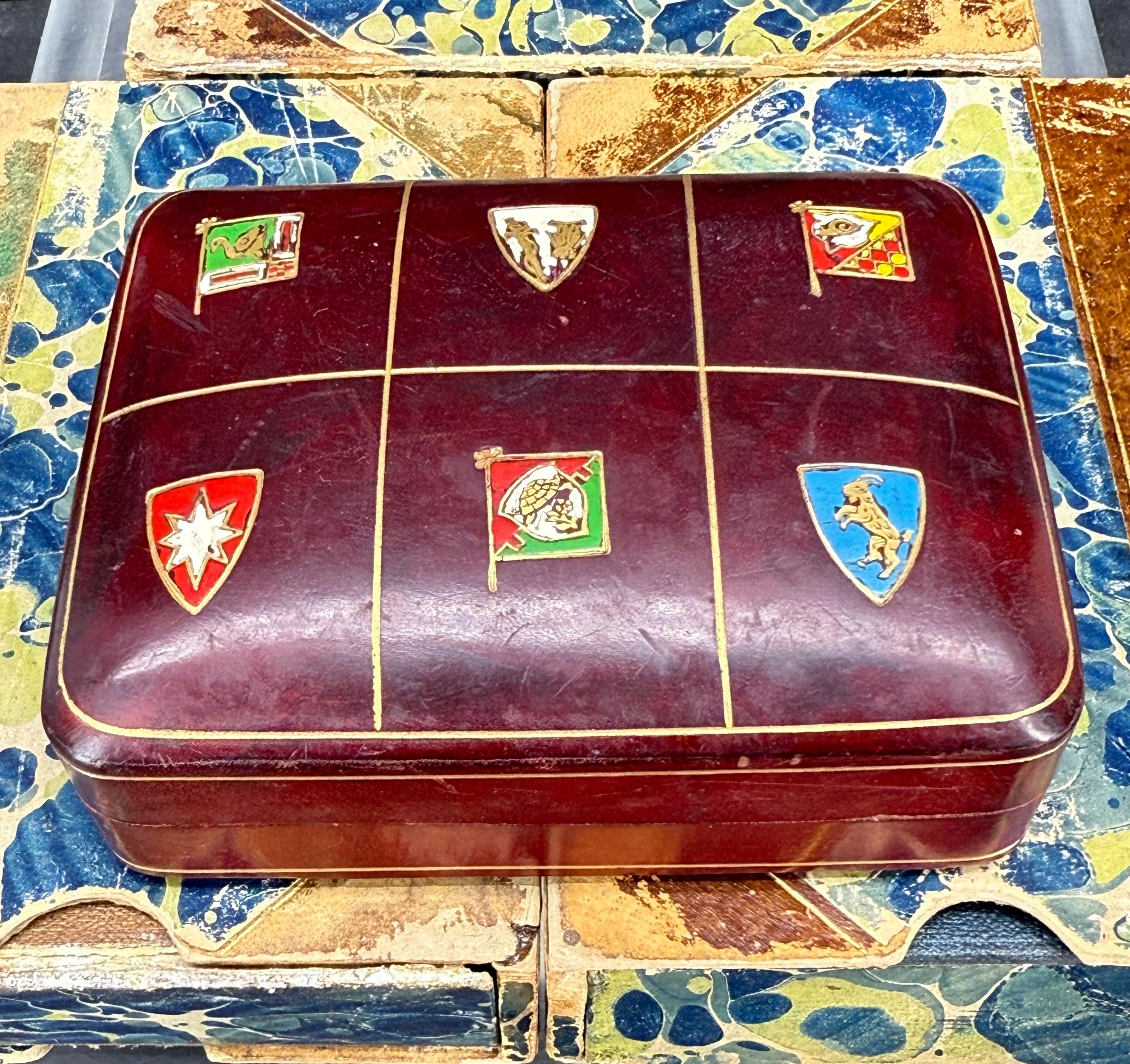 Beautifully molded Italian leather box with a raised style and features crests of coat of arms on the top. The interior of the box is leather as well. Fantastic piece to add to a collection either on a side table, coffee table or on a bookshelf in a