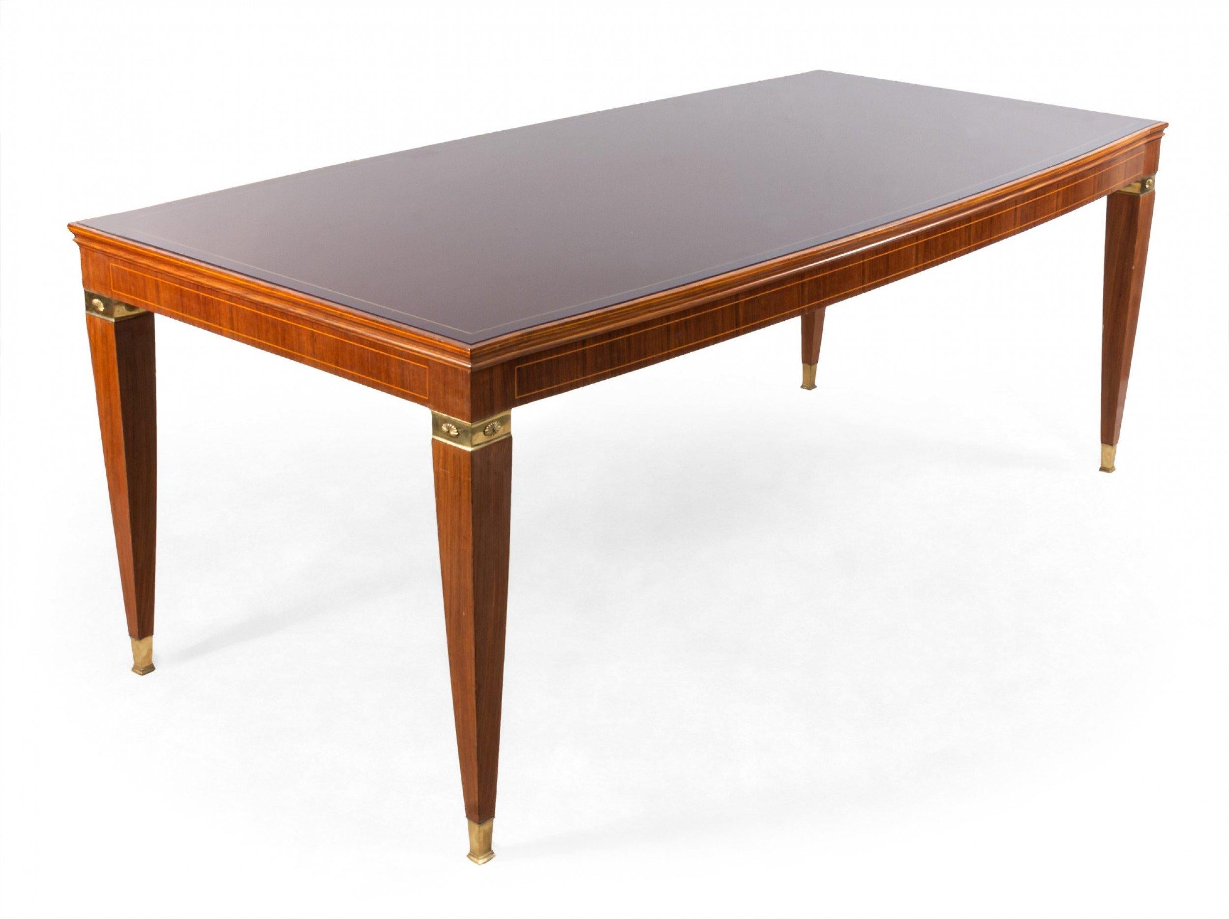 Italian midcentury dining table with wood construction, red glass top, and bronze mounted legs. (Attributed to PAULO BUFFA for ARRIGHI).