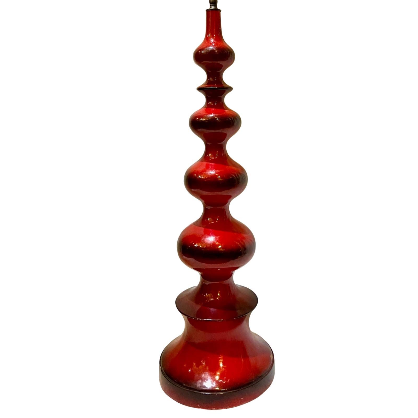 A single circa 1950's Italian red lacquered wood table lamp.

Measurements:
Height: 27”
Height to shade rest: 36.5