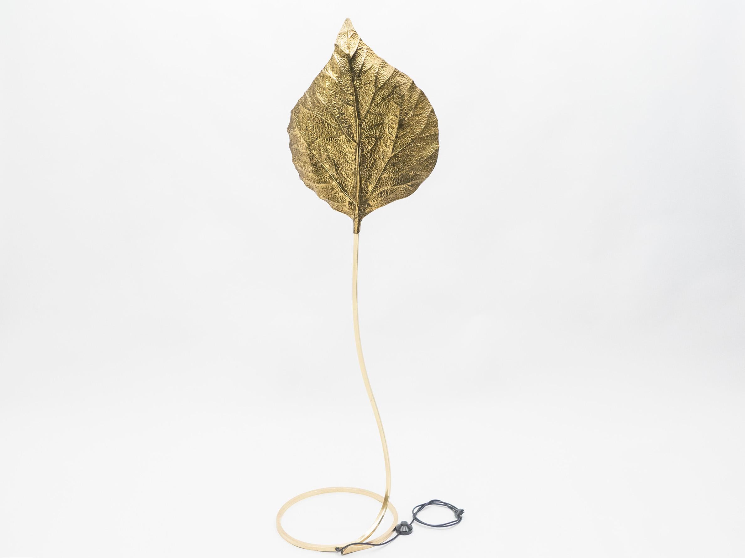 This iconic single leaf Rhubarb floor lamp by Tommaso Barbi was produced by Carlo Giorgi in Italy in the 1970s. The circular brass frame sweeps upwards from the base to support the large, decorative, hammered brass leaf. The handcrafted element