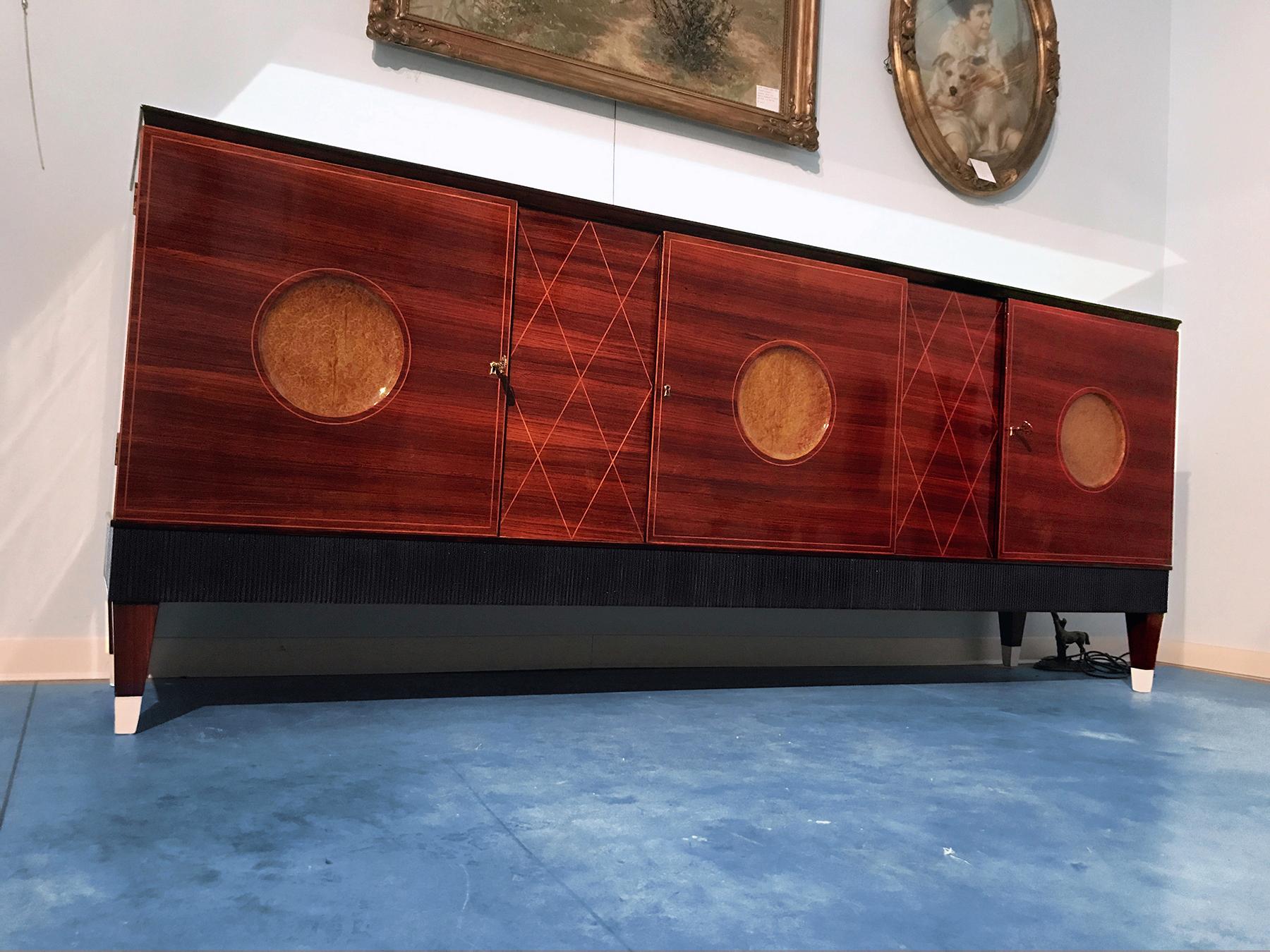 The design of this spectacular sideboard is attributed to Paolo Buffa in the 1950s.
It's forming part of a dining room suite very rare that's includes in addition other items such as: the Secretaire cabinet 1 door, Bar cabinet 2 doors /sold) and the