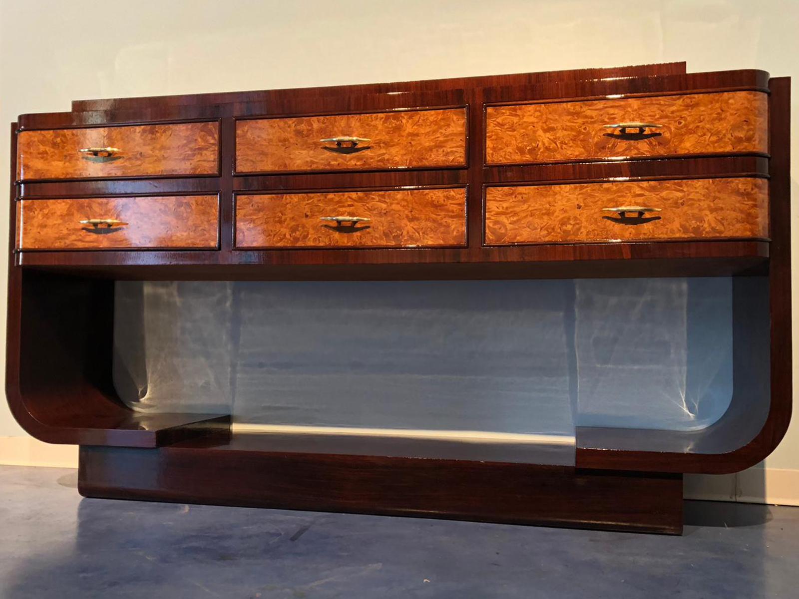 This unique rosewood piece is a wonderful example of Italian design, 1950s.
The line takes its inspiration from rationalism movement. In the central part six maple drawers with splendid handles. Perfectly restored, ready to use.