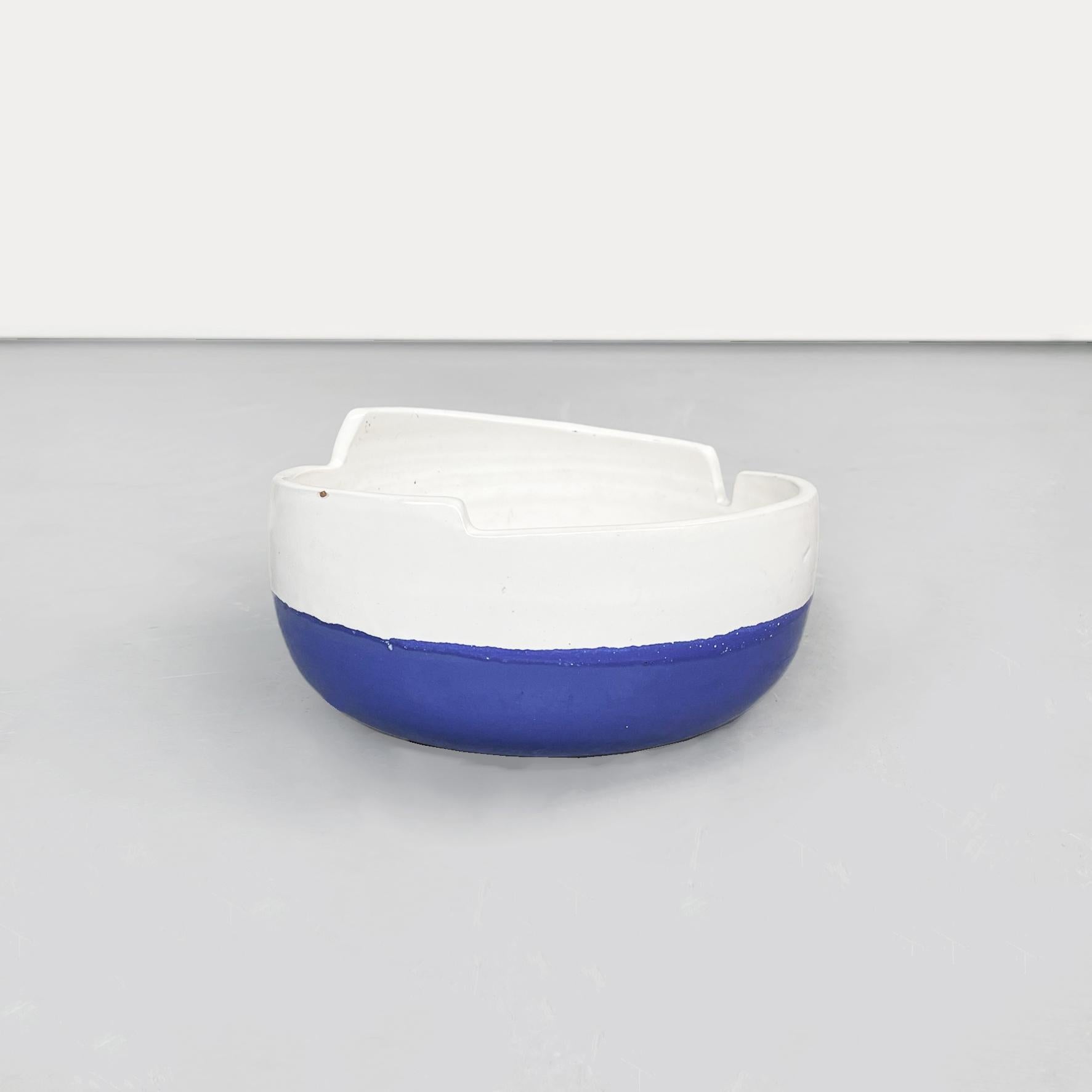 Italian mid-century round bowl in glazed ceramic blue n white by Sottsass, 1980s
Round bowl with irregular edge in glazed ceramic in white on the top and blue on the bottom.
Produced and designed by Ettore Sottsass in 1980s. Belonging to the