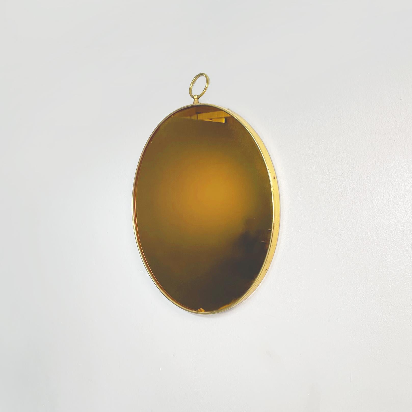 Italian mid-century Round brass mirror by Piero Fornasetti, 1960s
Round brass wall mirror. 
The mirror is original of the period and its  fantastic with gilded color, and the frame in brass conserve the original design of Fornasetti with the