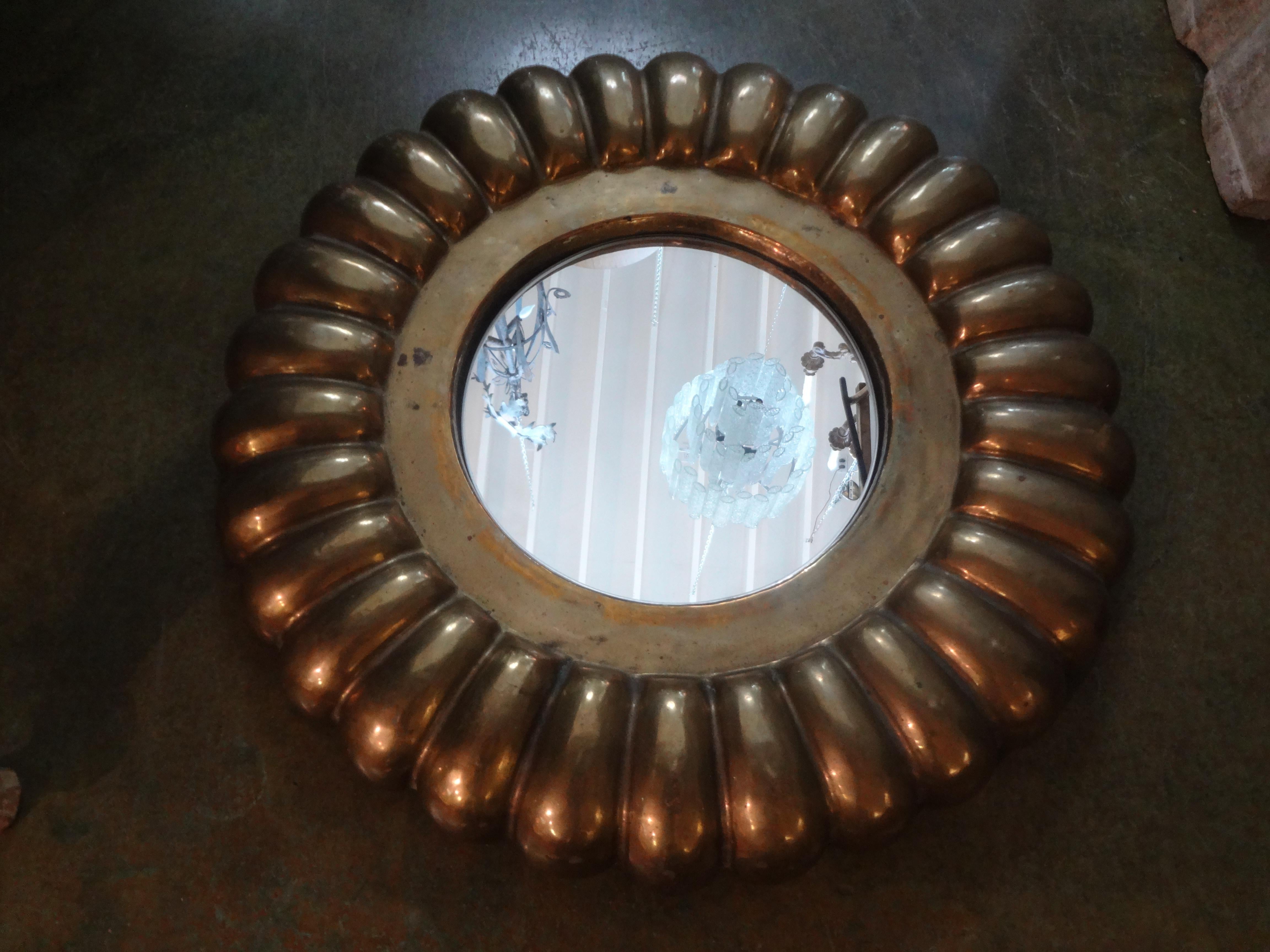 Stunning vintage Italian round brass mirror. This great Gio Ponti inspired Italian brass mirror has a beautiful scalloped design and a gorgeous warm patina. Perfect for a powder room or grouped with other mirrors.